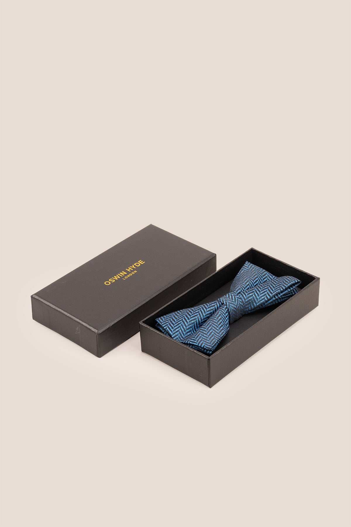 Oswin Hyde Herringbone Blue Bowtie, featuring a classic herringbone pattern. deep blue hue and textured fabric