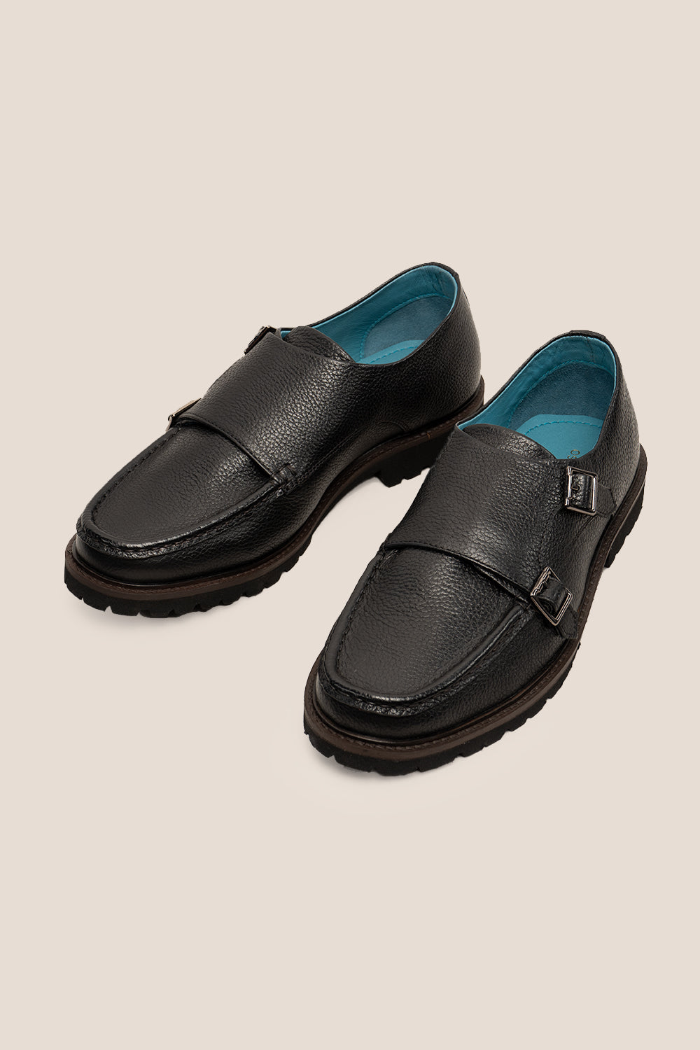 Men’s black monk strap shoes with lightweight cushioned sole and sleek leather upper.