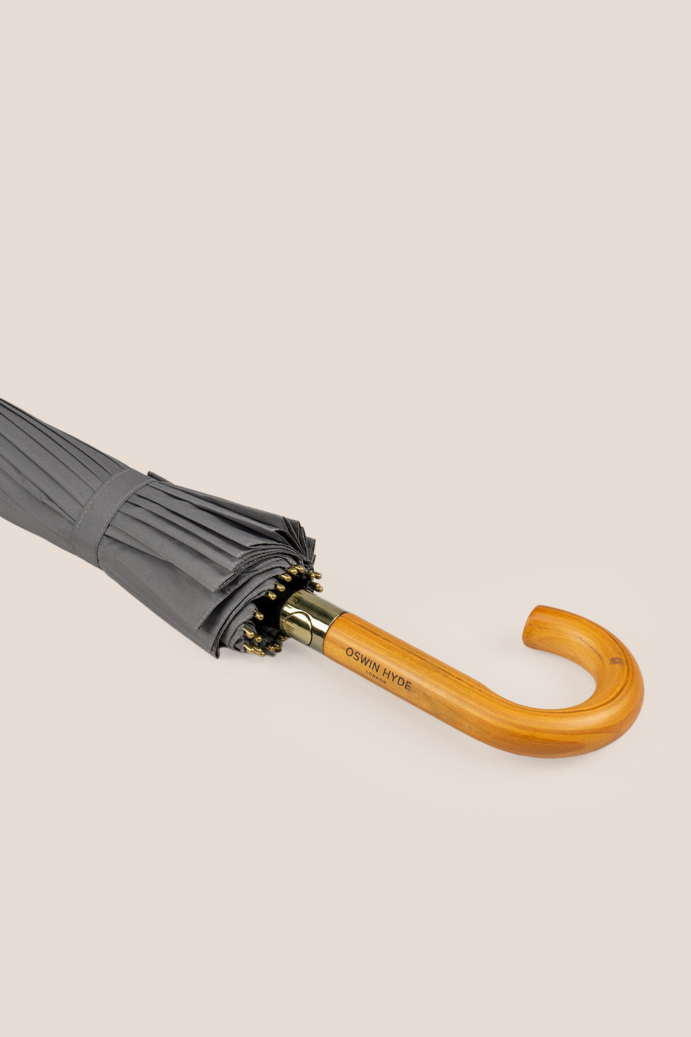 Joseph Grey men’s windproof umbrella with wooden J-handle, blending classic design with reliable durability for refined all-weather protection.