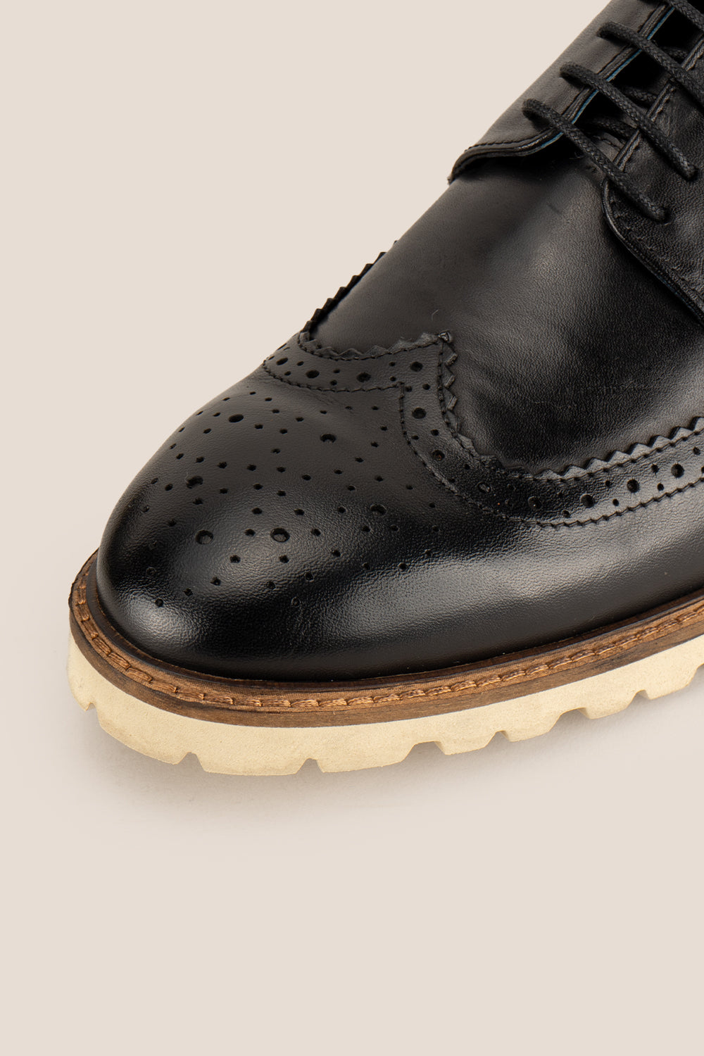 Eli black wide fit brogue men’s leather shoes featuring wingtip detail, premium leather construction, and a comfortable smart everyday silhouette.
