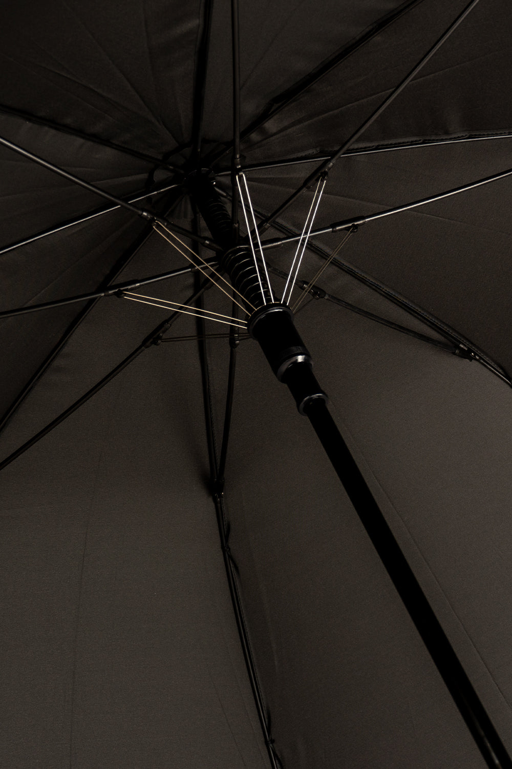 Jaxon Black men’s windproof umbrella featuring a sleek design and wooden J-handle, combining style and durability for reliable all-weather protection.