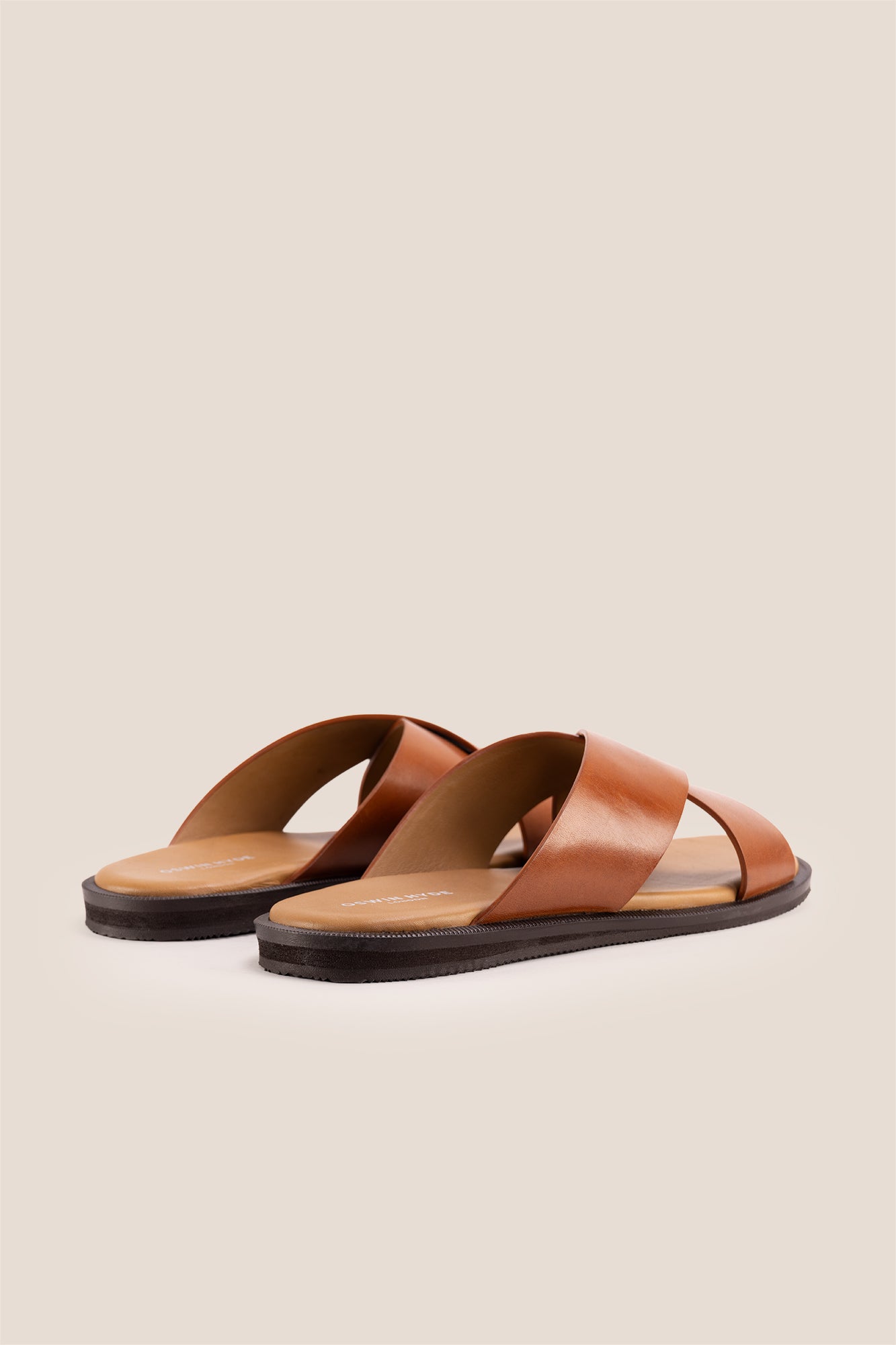 Men’s Ollie Tan sandals featuring a bold, wide criss-cross strap design in smooth high-grade tan leather.