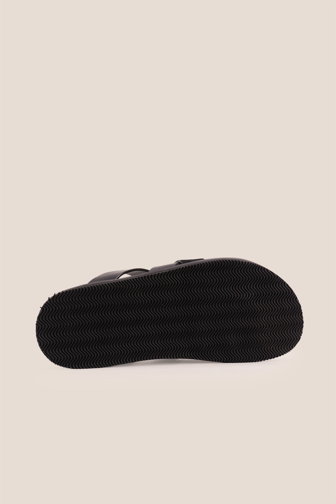 Men’s Rowan Black slide sandals featuring a minimalist black leather X-strap design and a sleek matte finish.