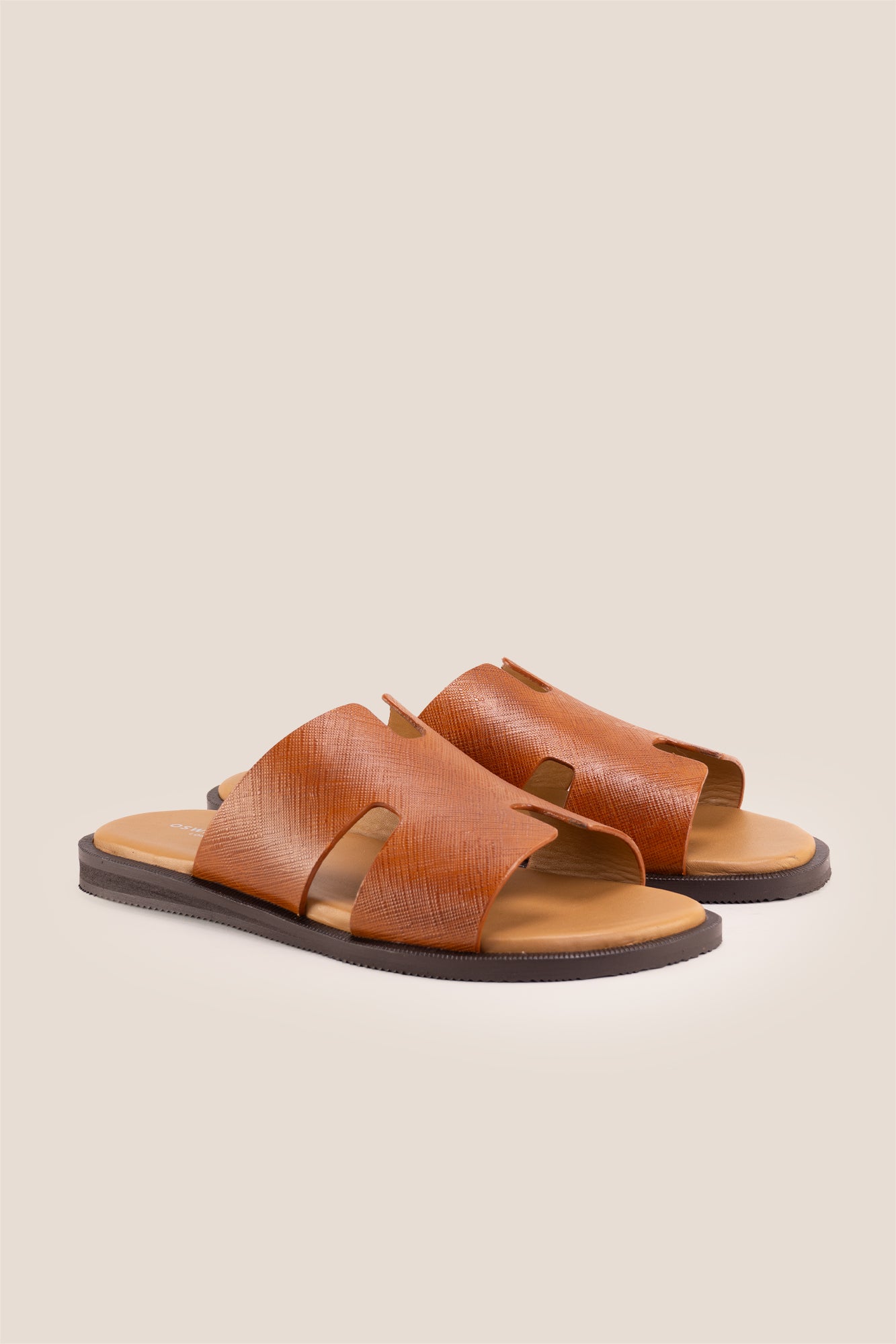 Men’s Phoenix Tan sandals in premium Saffiano leather featuring the signature hyde strap H-frame design.
