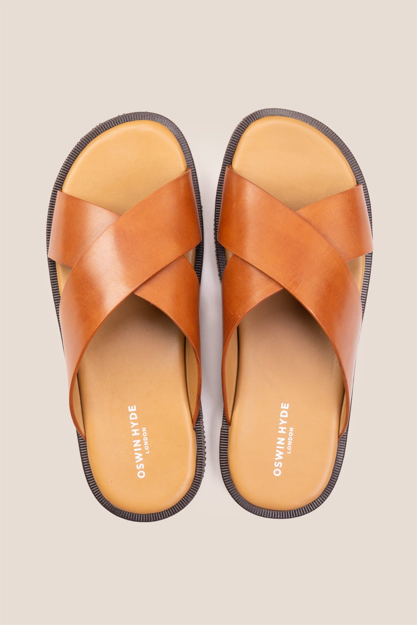 Men’s Ollie Tan sandals featuring a bold, wide criss-cross strap design in smooth high-grade tan leather.