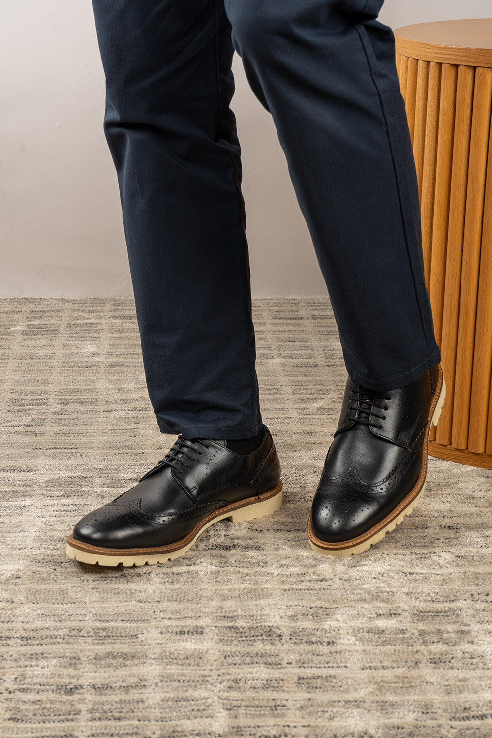 Eli black wide fit brogue men’s leather shoes featuring wingtip detail, premium leather construction, and a comfortable smart everyday silhouette.