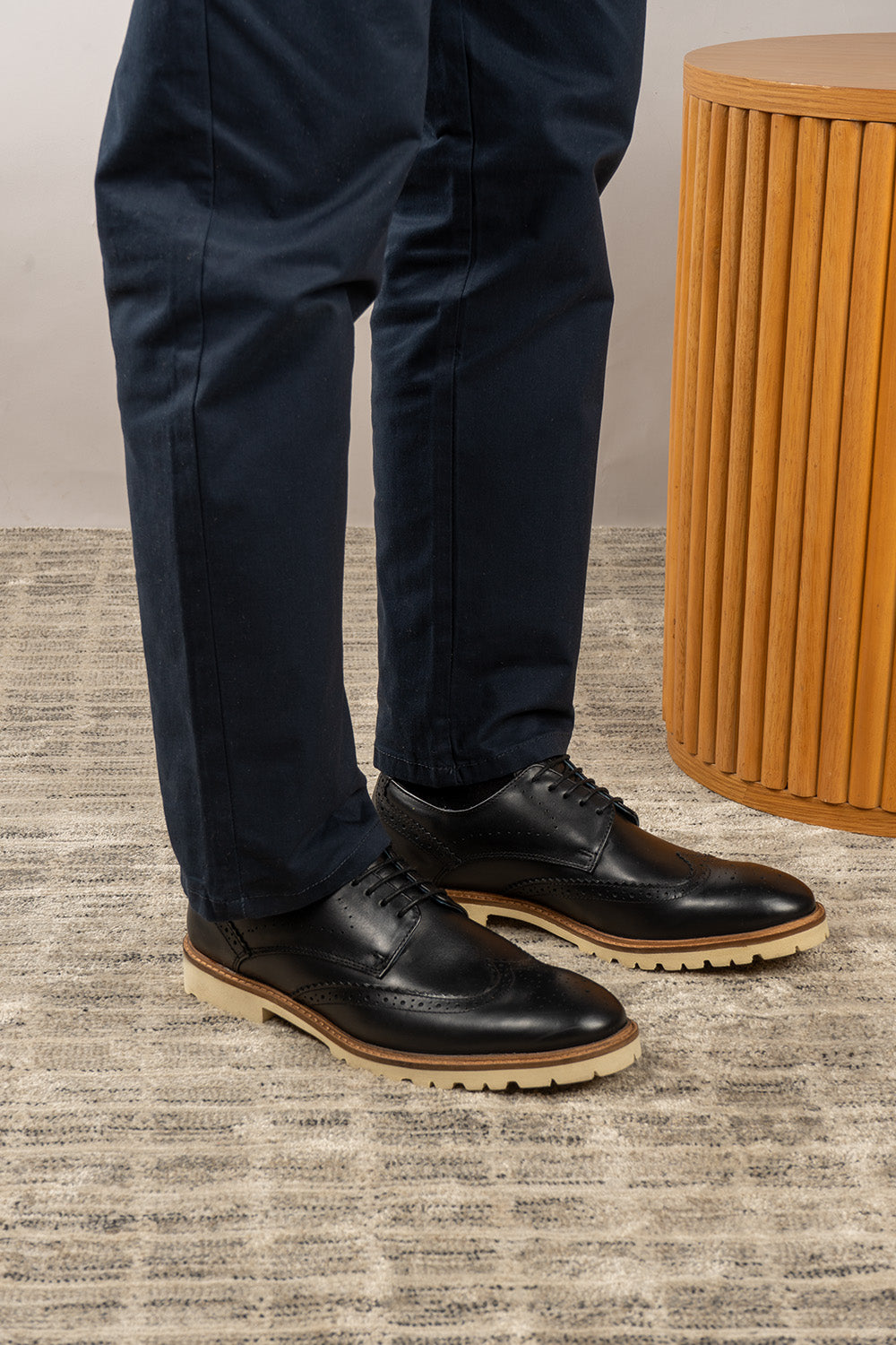 Eli black wide fit brogue men’s leather shoes featuring wingtip detail, premium leather construction, and a comfortable smart everyday silhouette.