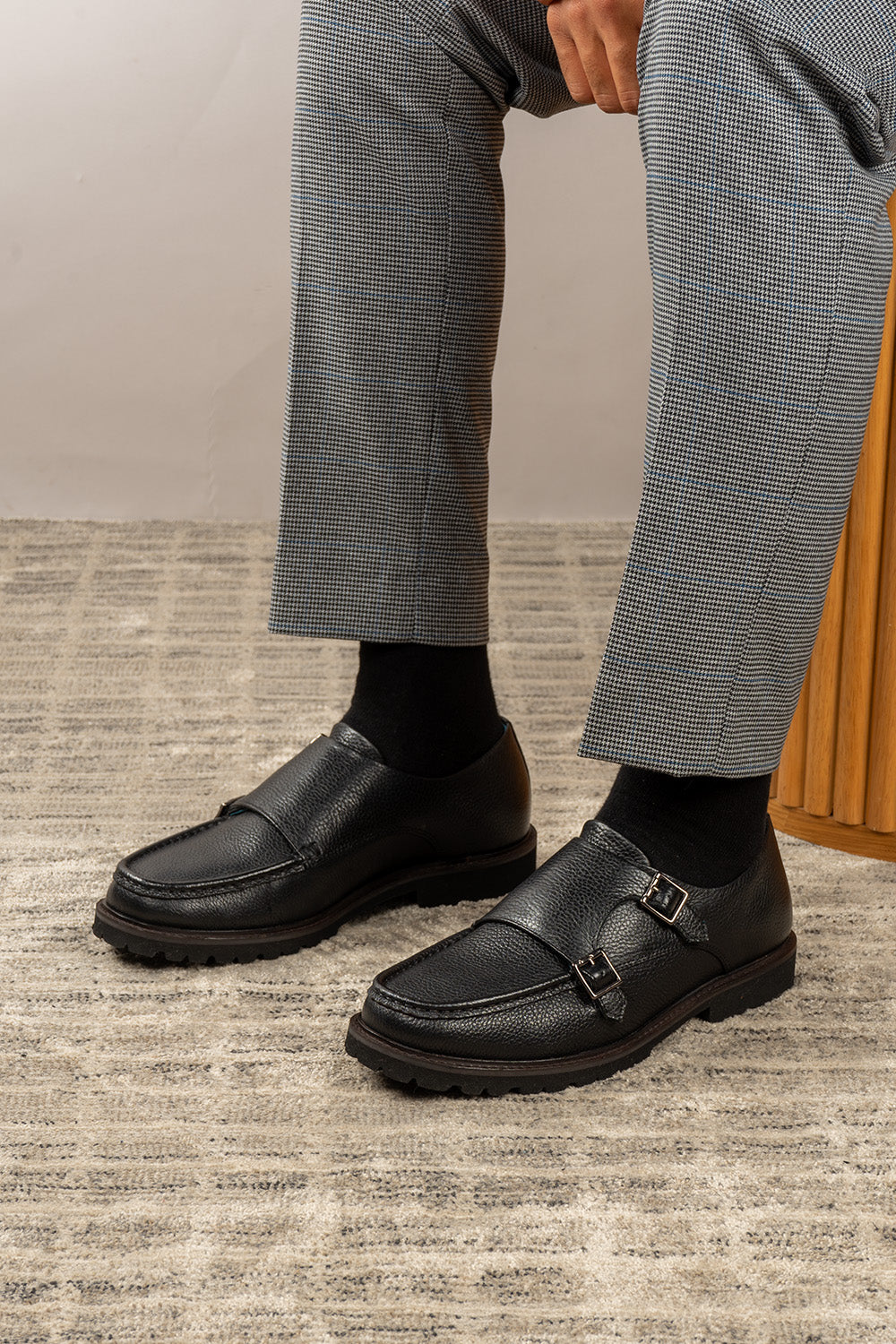 Men’s black monk strap shoes with lightweight cushioned sole and sleek leather upper.