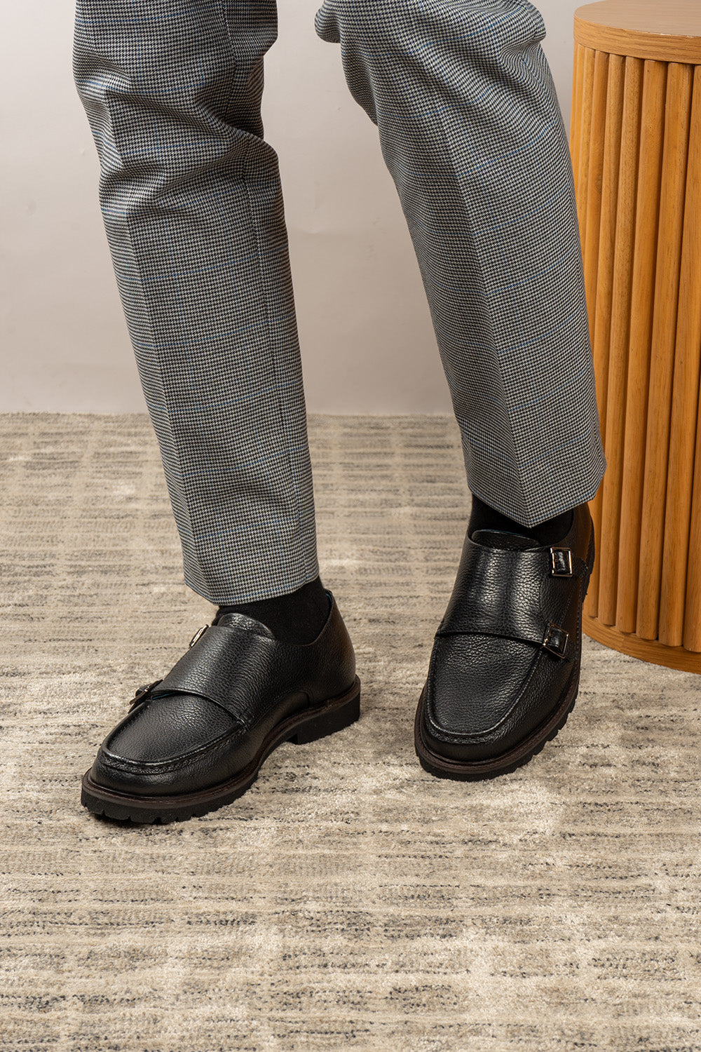 Men’s black monk strap shoes with lightweight cushioned sole and sleek leather upper.