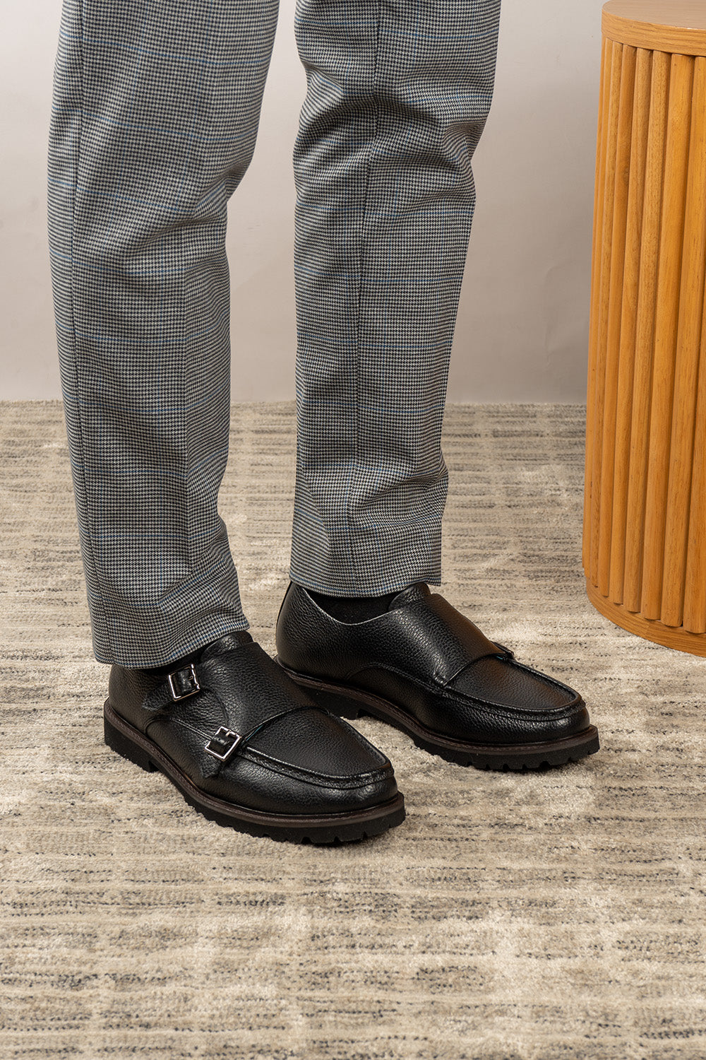 Men’s black monk strap shoes with lightweight cushioned sole and sleek leather upper.