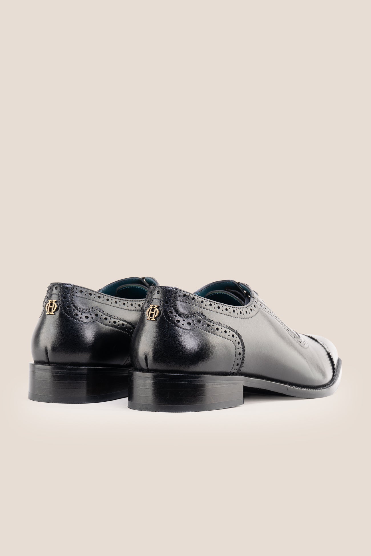 The men's smart black shoes showcase a sleek cap-toe design with delicate brogue punch detailing and premium full-grain leather, perfect for business settings, weddings, and formal occasions.
