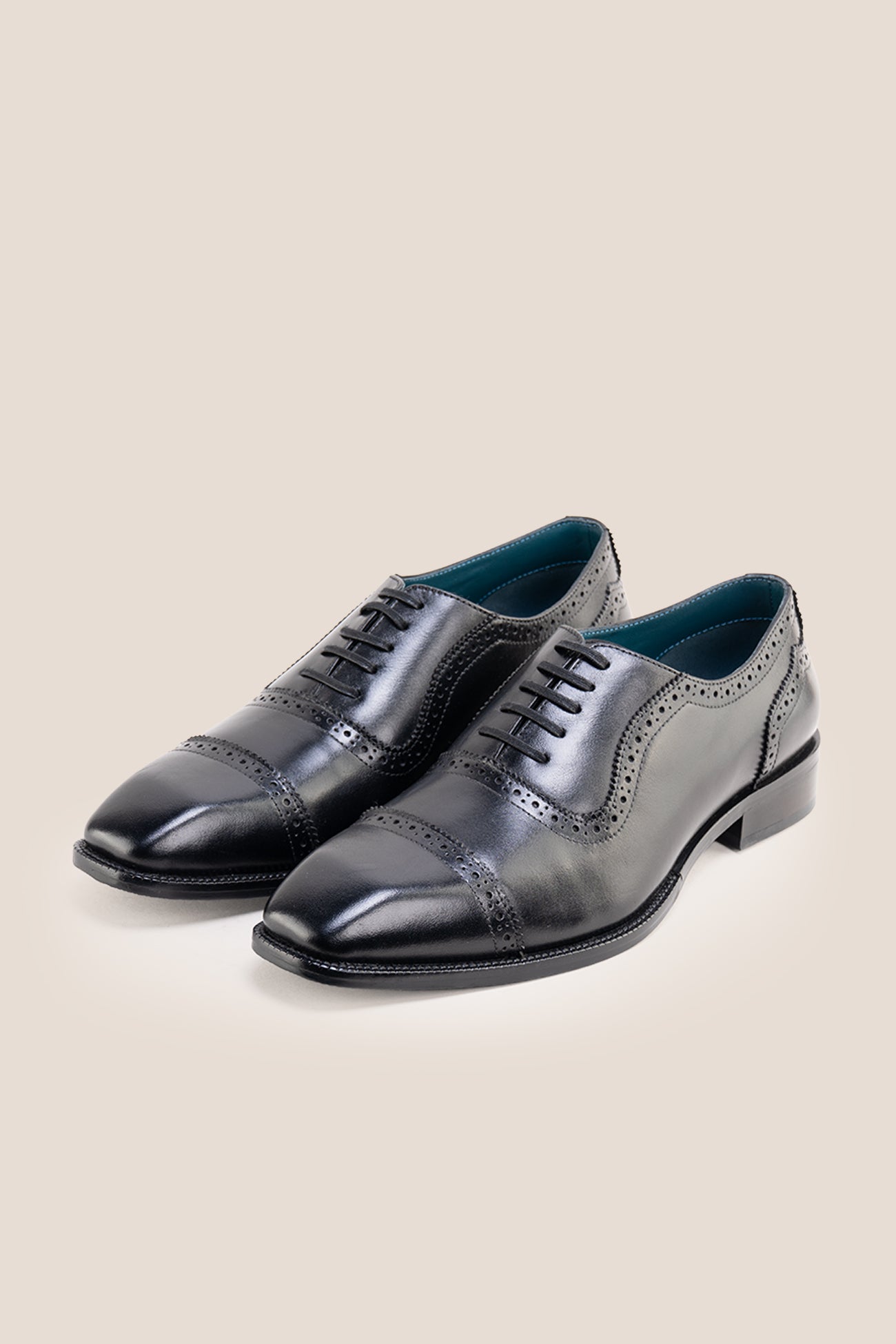 The men's smart black shoes showcase a sleek cap-toe design with delicate brogue punch detailing and premium full-grain leather, perfect for business settings, weddings, and formal occasions.