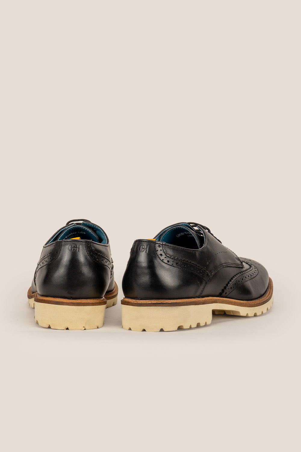 Eli black wide fit brogue men’s leather shoes featuring wingtip detail, premium leather construction, and a comfortable smart everyday silhouette.