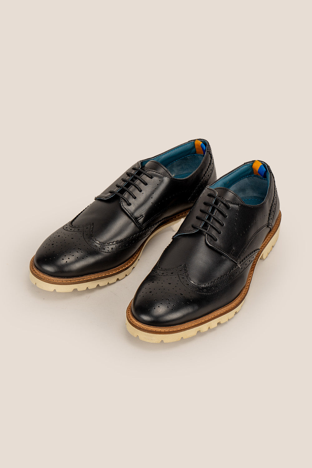 Eli black wide fit brogue men’s leather shoes featuring wingtip detail, premium leather construction, and a comfortable smart everyday silhouette.