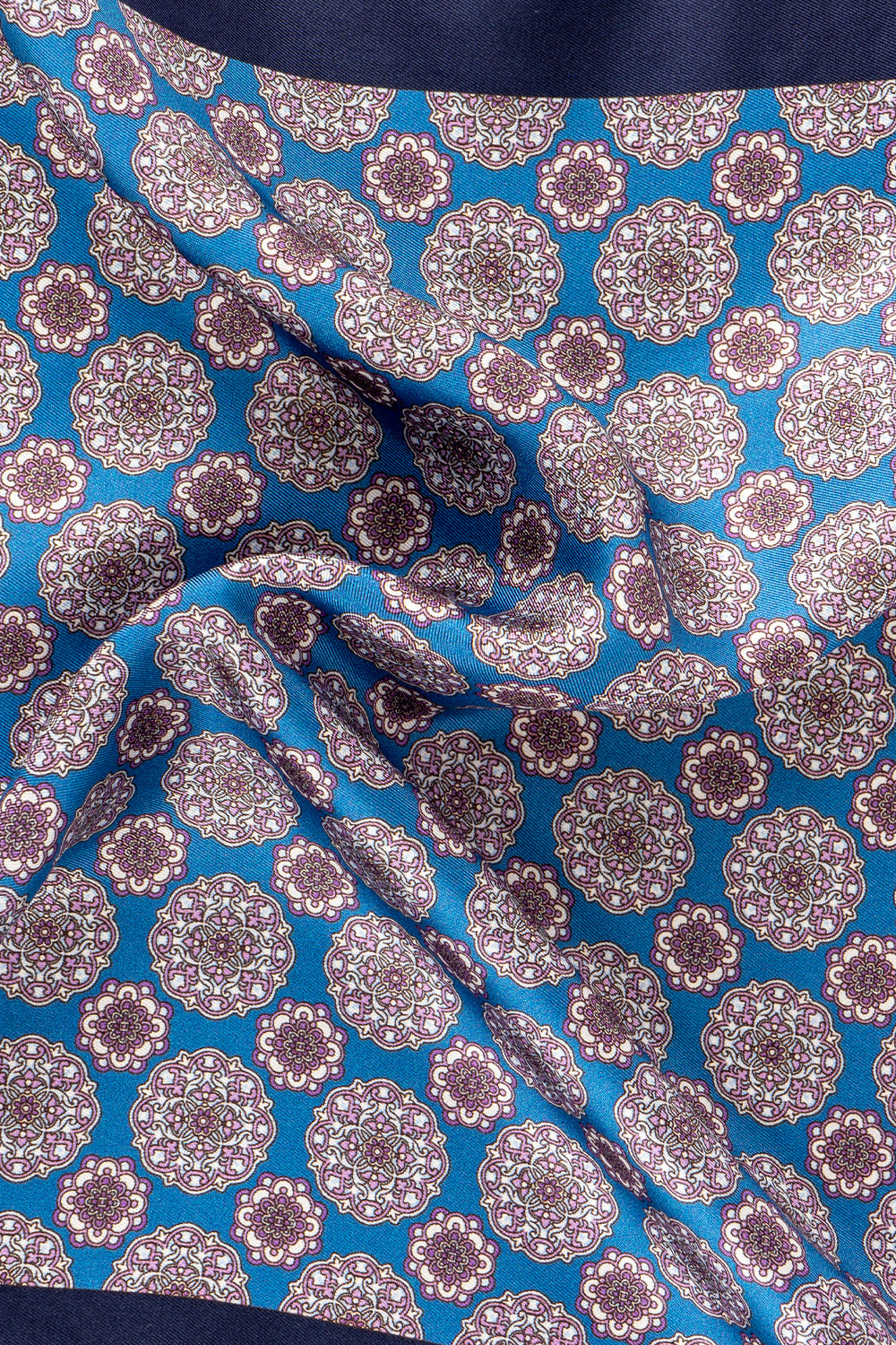 Men’s blue silk handkerchief with an intricate geometric pattern, perfect for weddings, formal occasions, or sophisticated smart dressing.