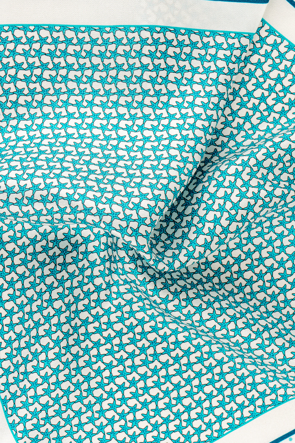 Blue silk pocket square handkerchief with a blue star print and four versatile folds, ideal for wedding, business or refined casual wear.