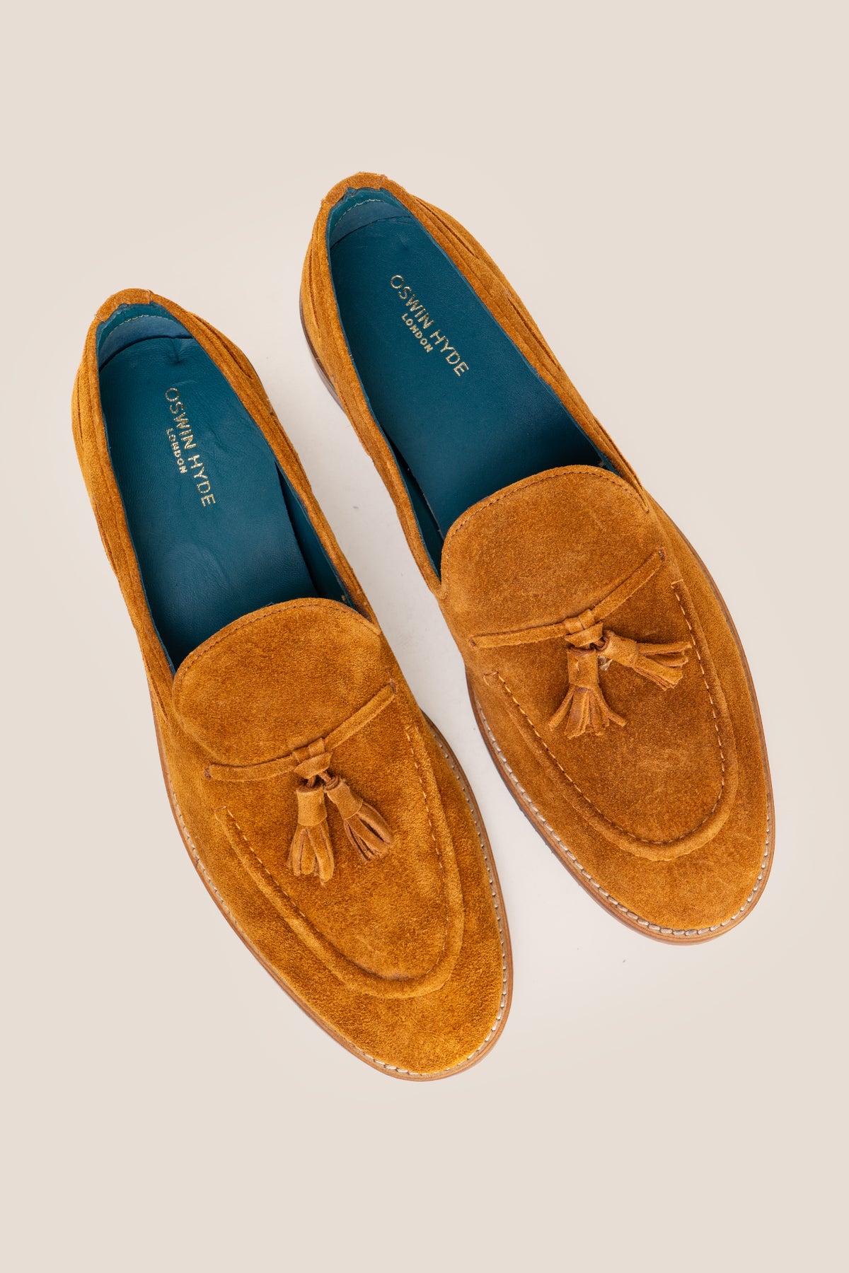 Men's Issac Tobacco Suede tassel loafers crafted from premium suede with a cushioned footbed and slip-on design.