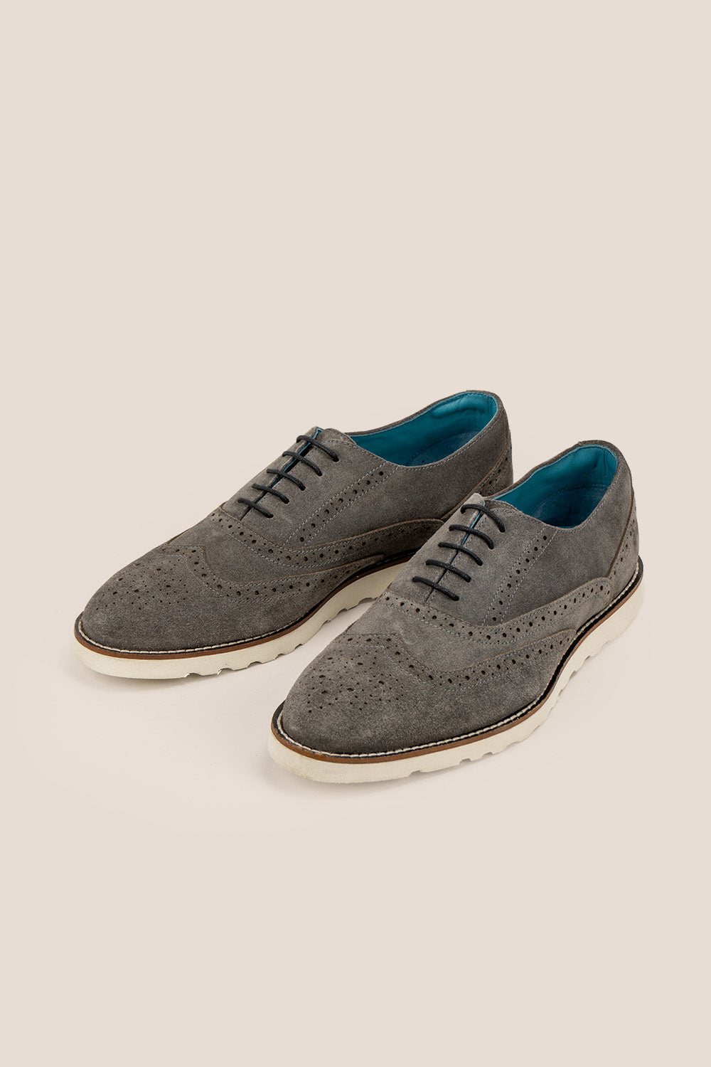 Men’s Tyler grey suede Oxford brogue trainer shoes with perforated detailing, leather lining, and a sleek white sole for elegant everyday wear.