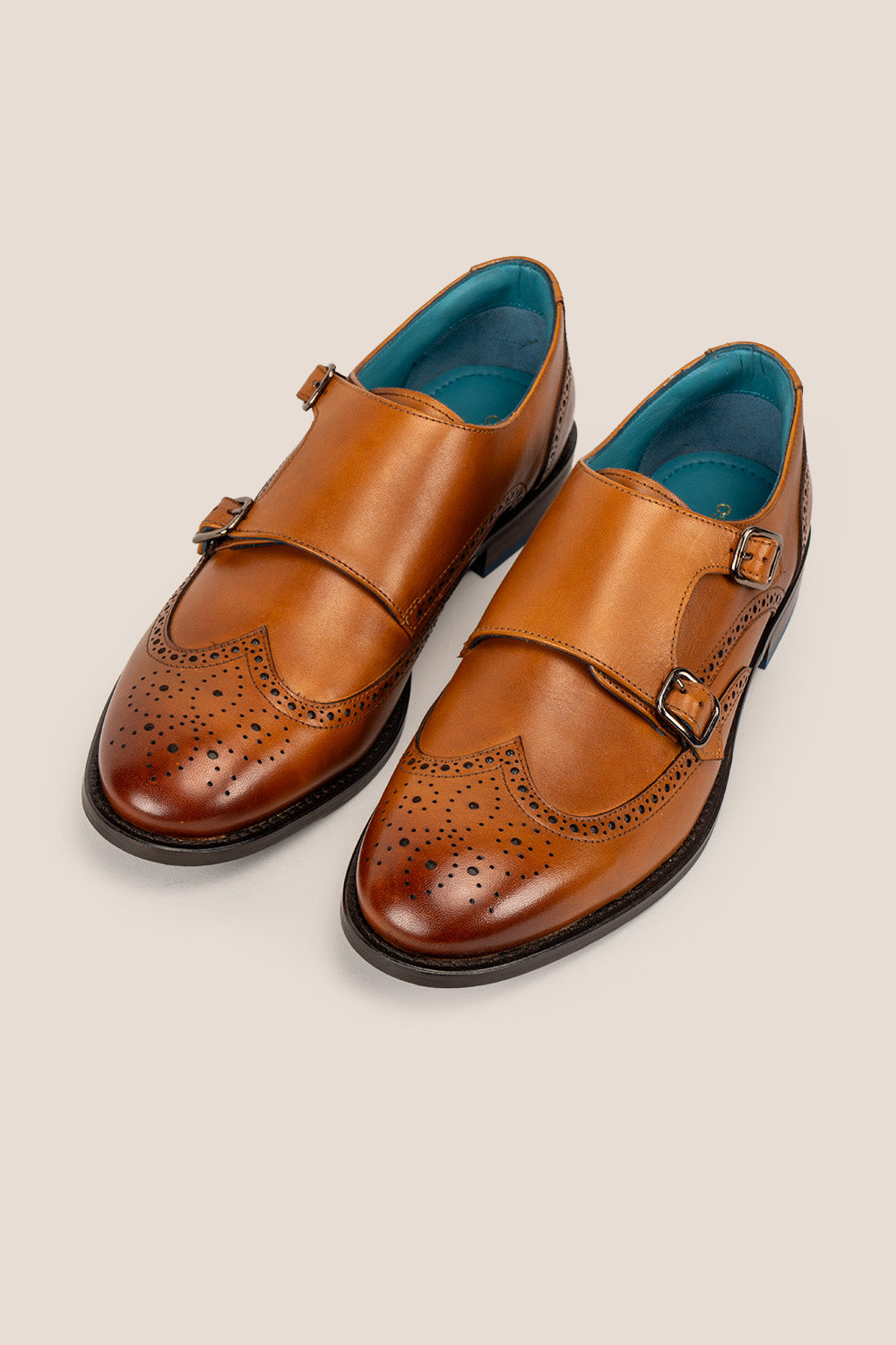 Crafted in rich tan leather, the Warren Monk Strap Brogue blends classic broguing with modern monk straps—ideal for men seeking stylish, versatile formal shoes.