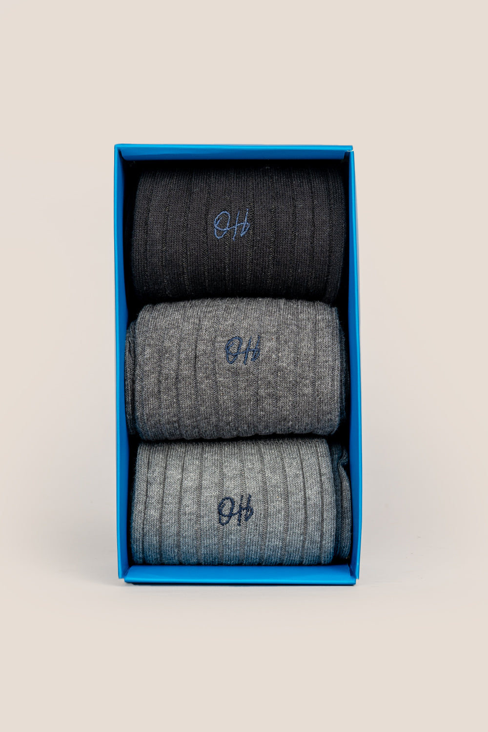Oswin Hyde Mono three pairs of luxurious cotton socks for men in black, light grey, and dark grey.