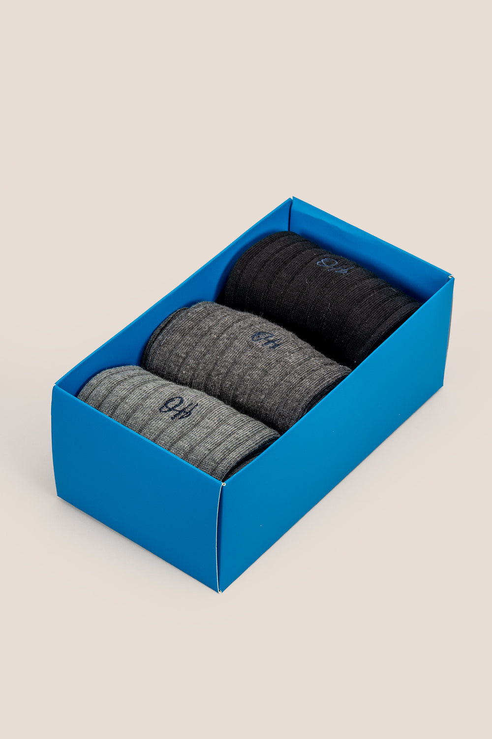 Oswin Hyde Mono three pairs of luxurious cotton socks for men in black, light grey, and dark grey.