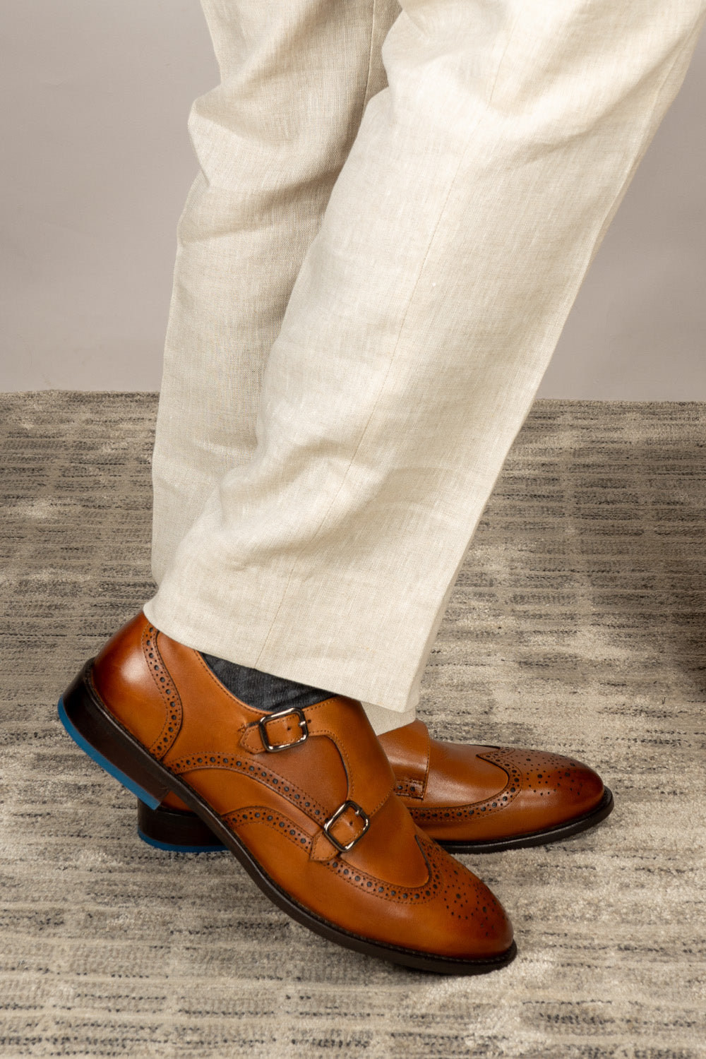 Crafted in rich tan leather, the Warren Monk Strap Brogue blends classic broguing with modern monk straps—ideal for men seeking stylish, versatile formal shoes.