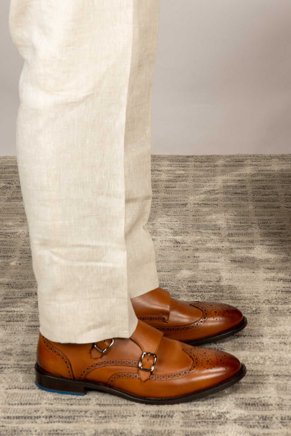 Crafted in rich tan leather, the Warren Monk Strap Brogue blends classic broguing with modern monk straps—ideal for men seeking stylish, versatile formal shoes.