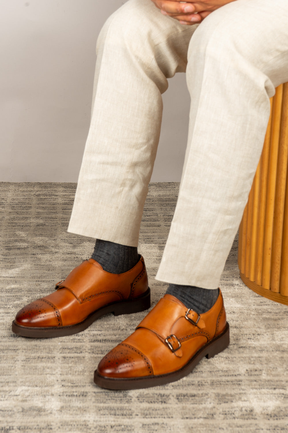 Men’s Shelby tan leather monk strap brogue shoes featuring intricate broguing and premium craftsmanship for formal and smart-casual occasions.