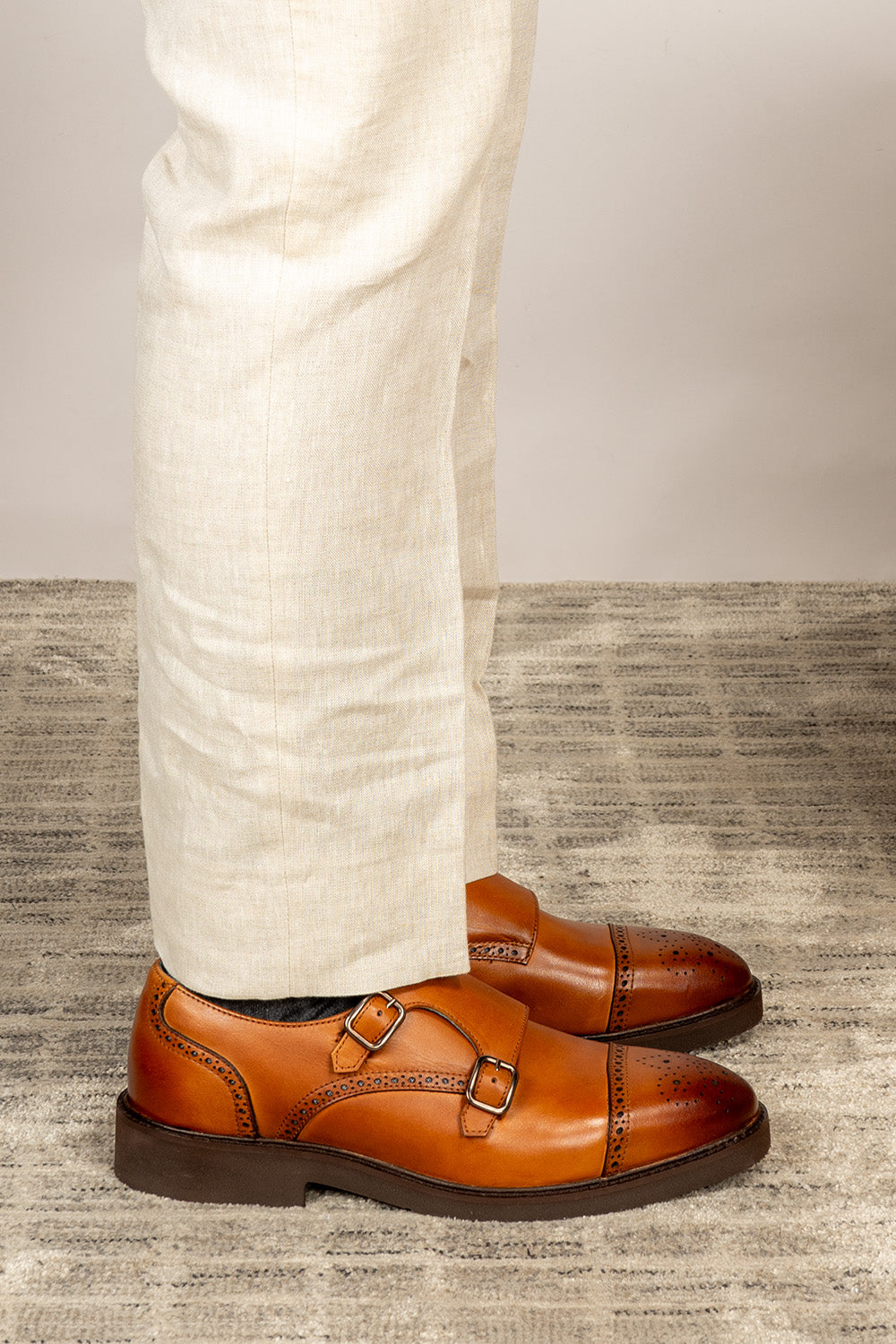 Men’s Shelby tan leather monk strap brogue shoes featuring intricate broguing and premium craftsmanship for formal and smart-casual occasions.