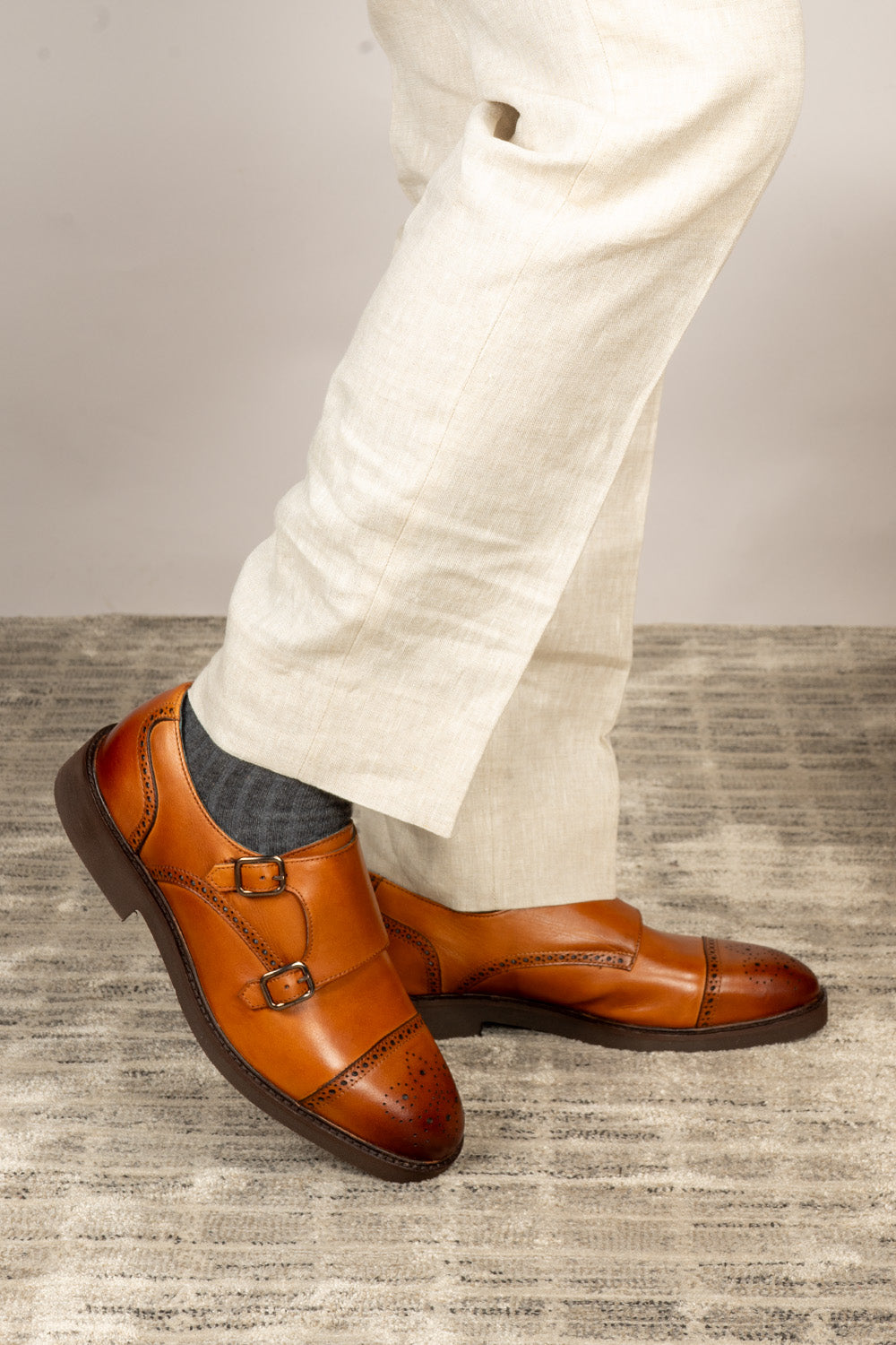 Men’s Shelby tan leather monk strap brogue shoes featuring intricate broguing and premium craftsmanship for formal and smart-casual occasions.