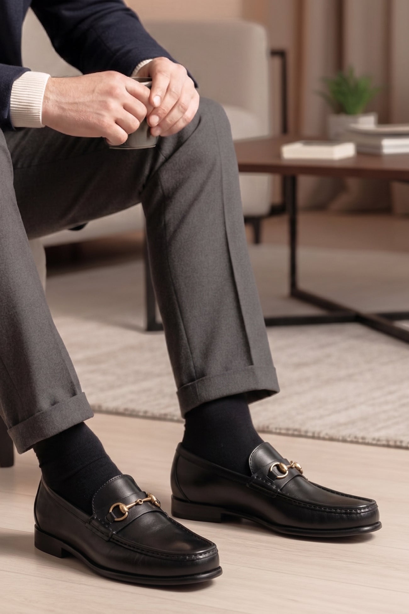 Pair of Oswin Hyde Samuel black leather horsebit loafers with gold buckle detail and teal lining.