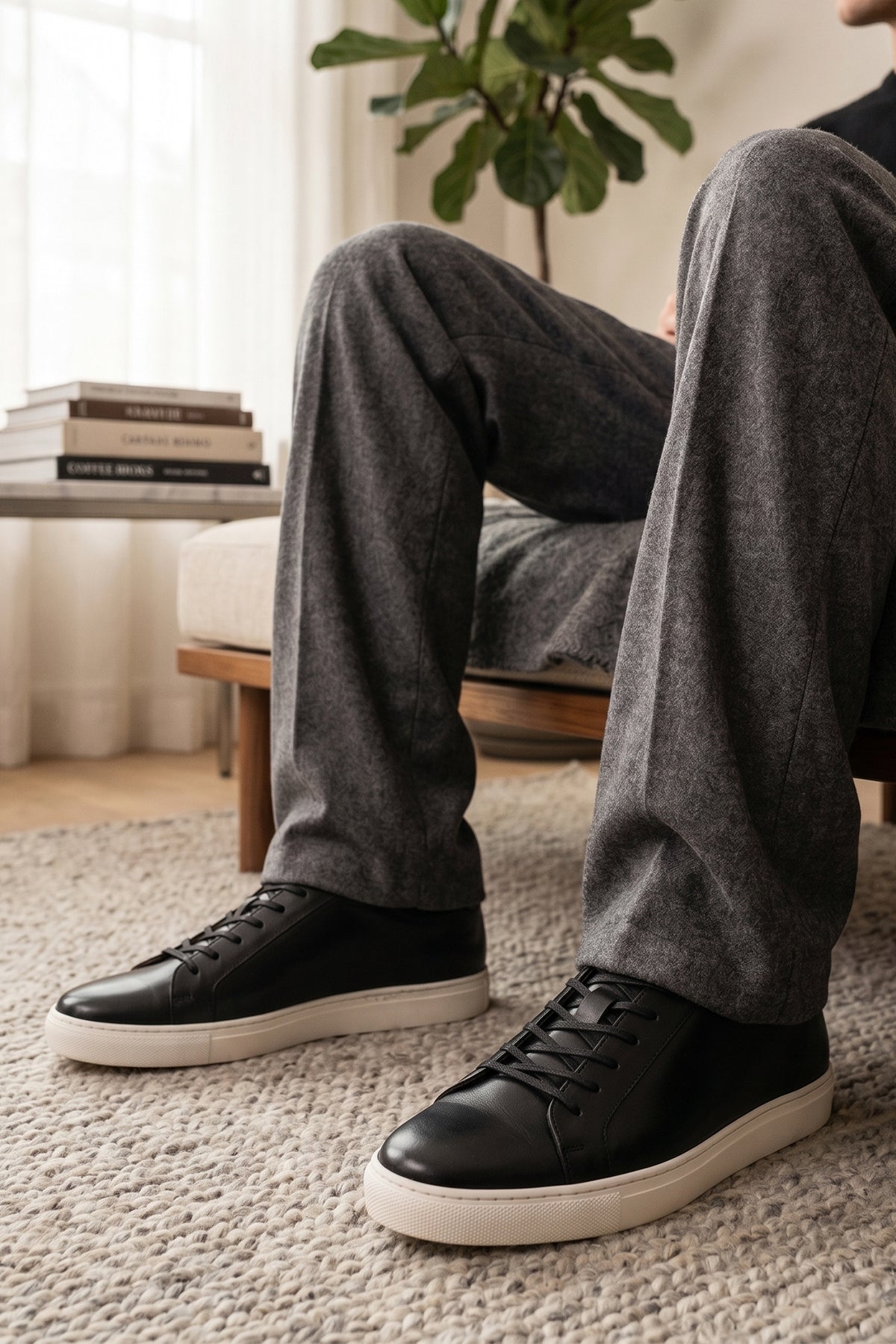 Model wearing Black leather sneaker on a beige background