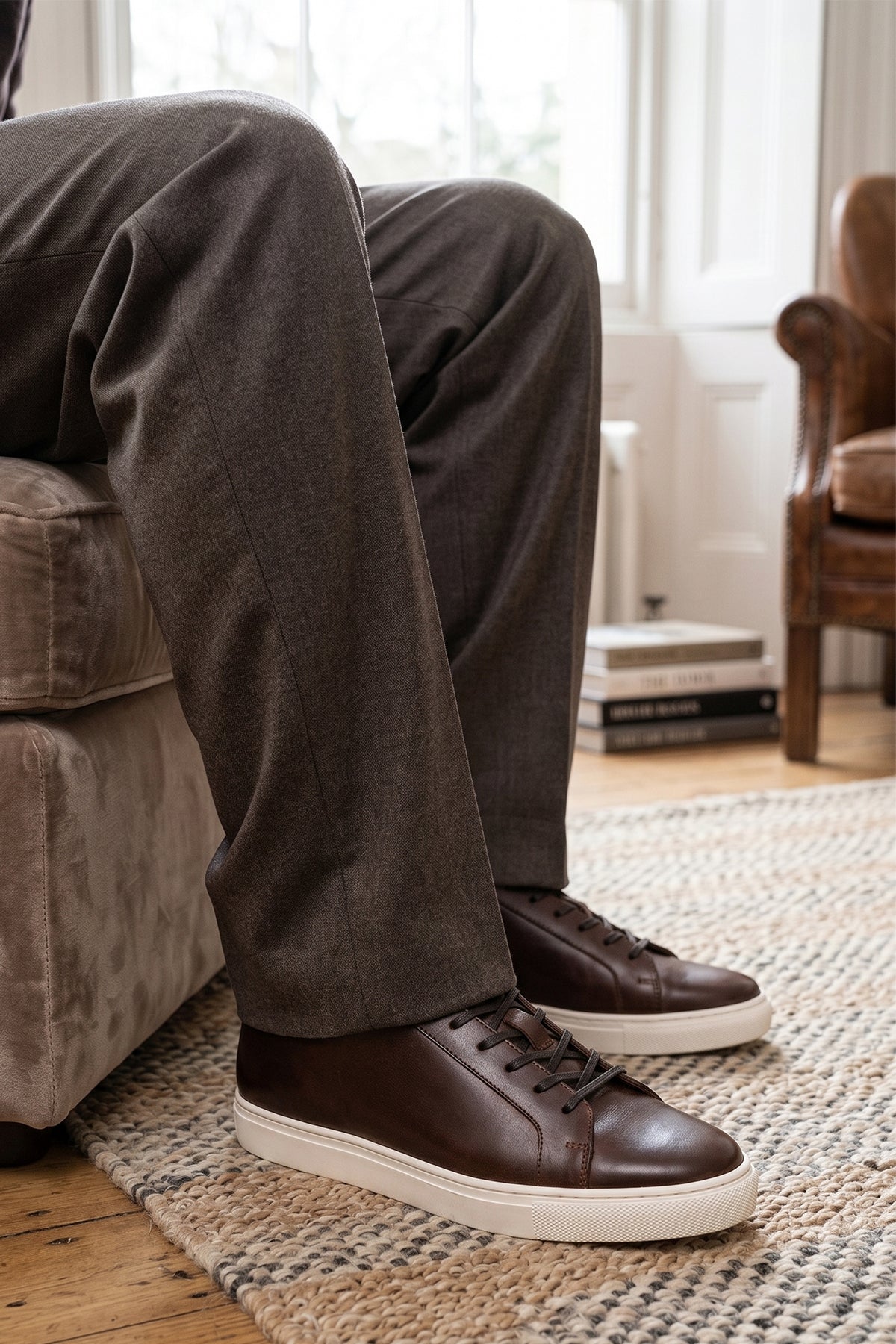 Model wearing Harper brown leather classic trainers for men featuring durable leather upper and comfortable sole, ideal for casual and smart-casual wear.