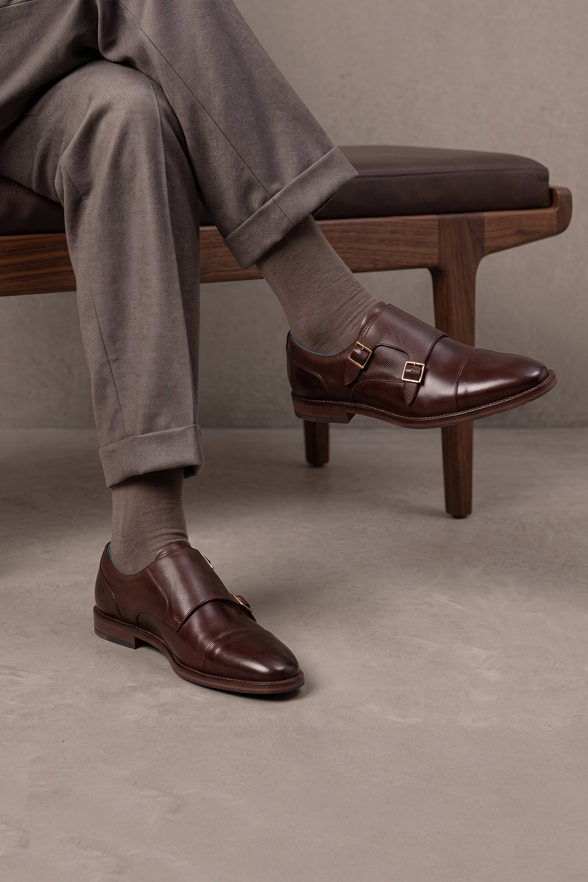 Model wearing Kayden Brown leather monk strap shoes by OSWIN HYDE for men. Toe cap designed with saffiano print, cushioned insole and padded topline.