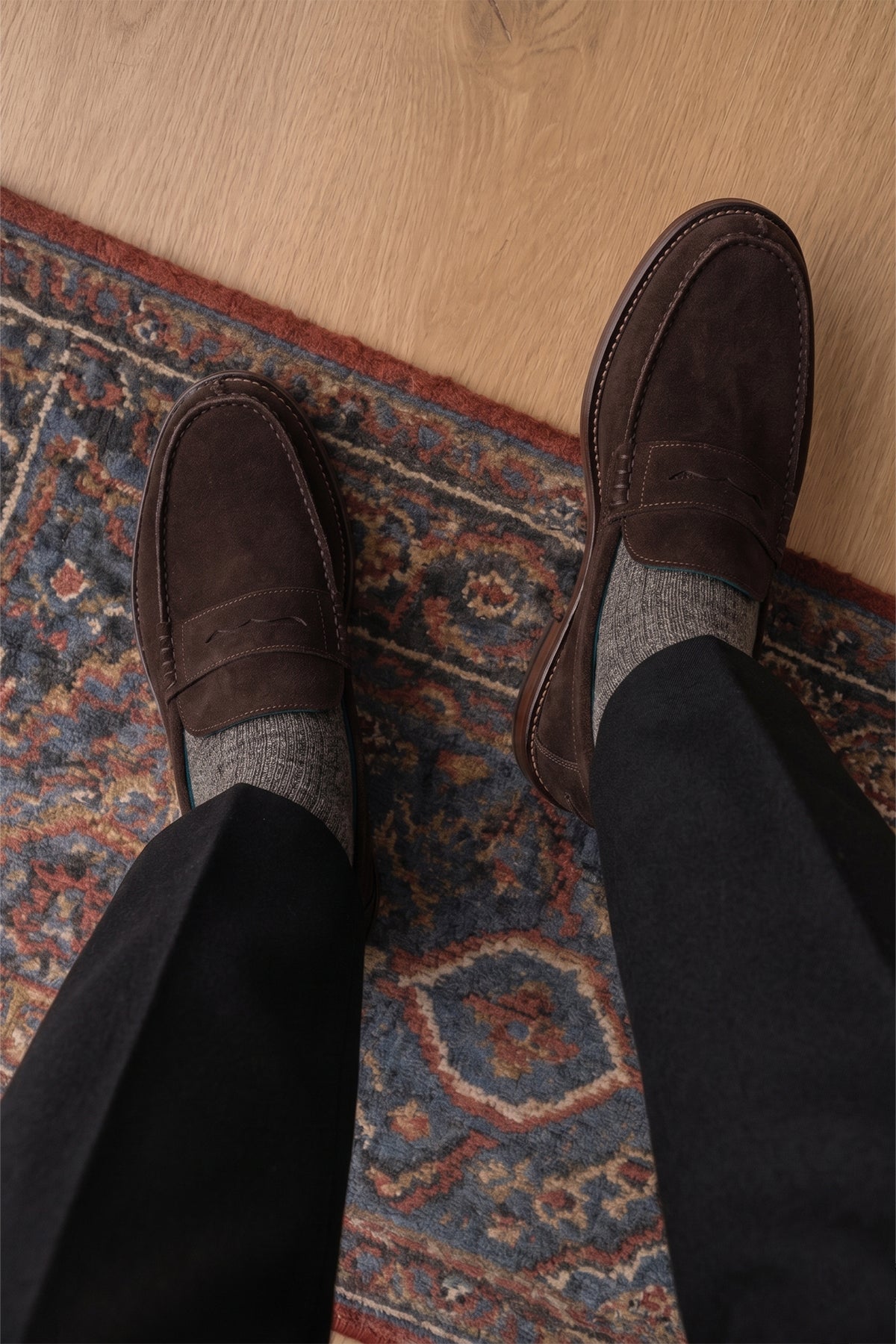 Model wearing Peter Brown Suede leather penny loafers for men. Classic and stylish, these loafers provide comfort, durability, and a refined look for any occasion.