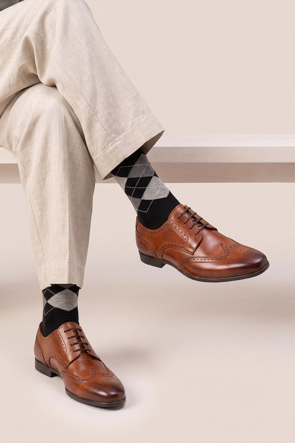 Model wearing Premium Scotch Argyle cotton socks designed by Oswin Hyde for the discerning gentleman.