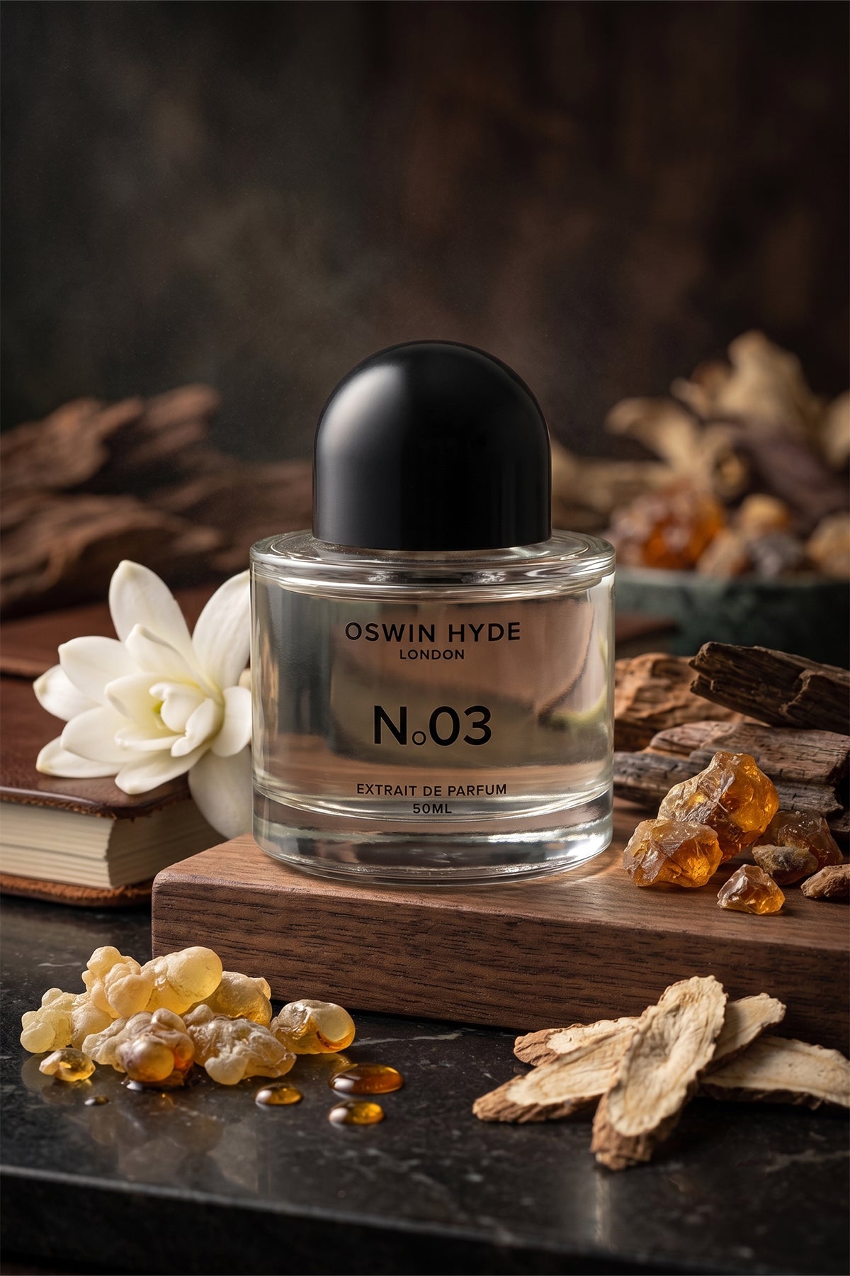 Oswin Hyde London N.03 Extrait de Parfum 50ml bottle displayed on wood with amber resin, white florals, and wood notes.