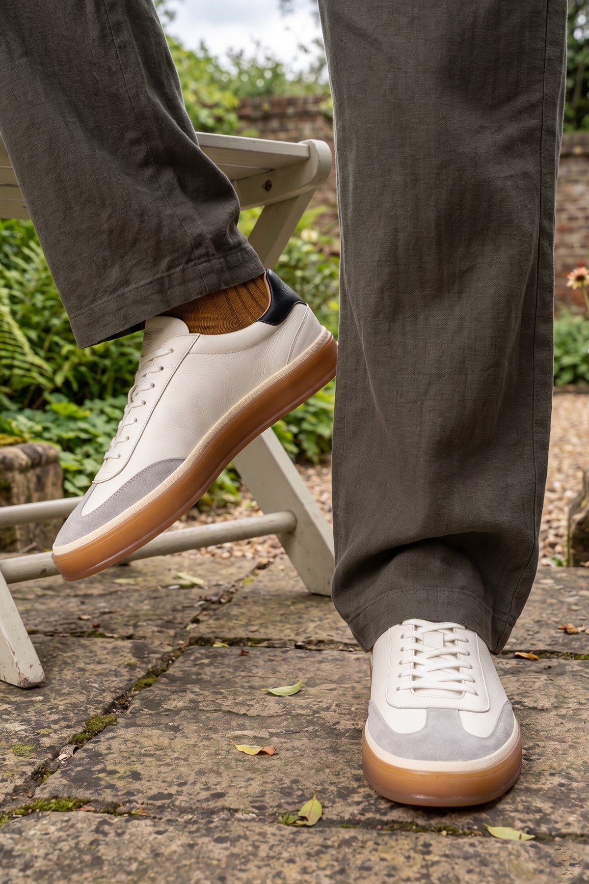 Model wearing Smith White leather sneakers for men, showcasing a refined seven-eyelet design that embodies contemporary style. Made from top-quality leather