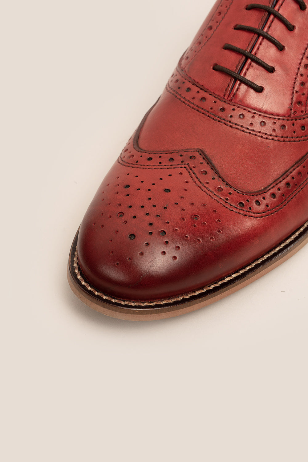 Winston cherry leather Oxford brogues for men featuring wingtip perforations and polished finish, ideal for formal and smart-casual occasions.