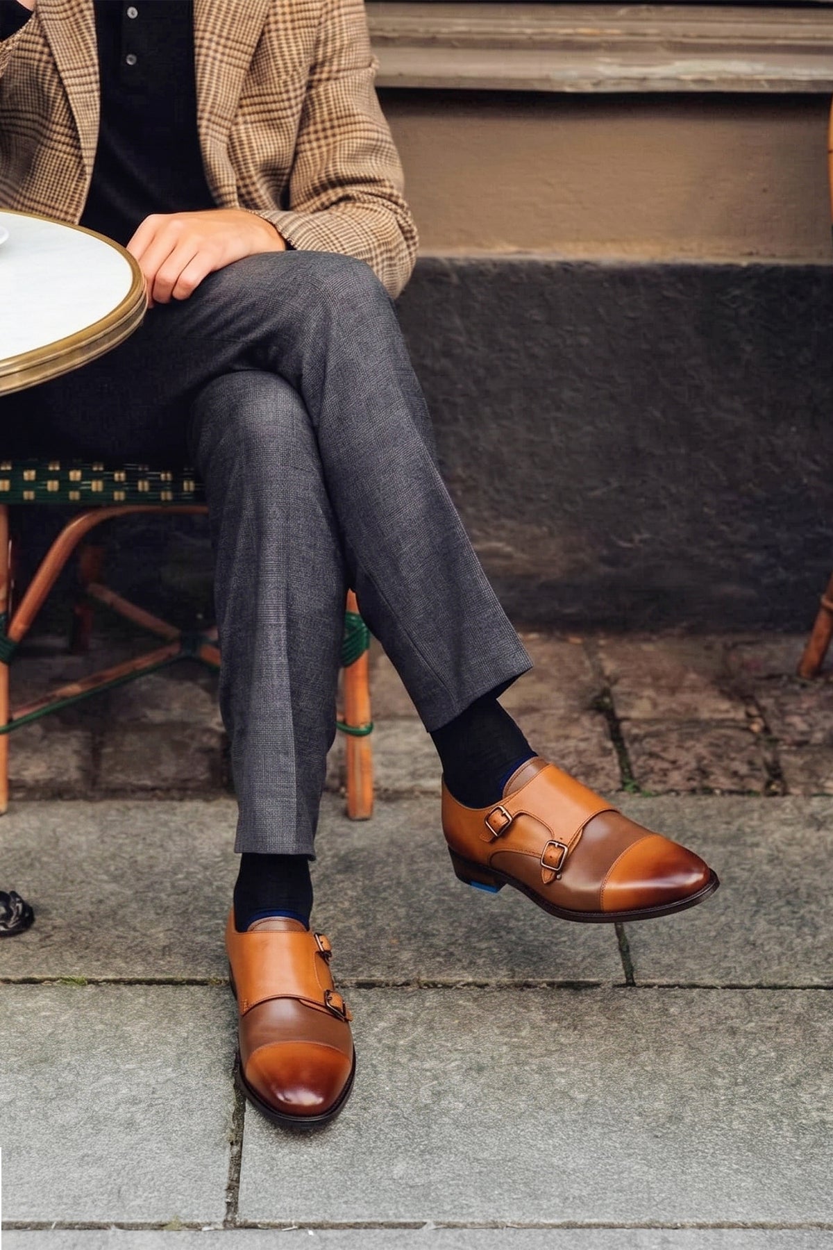 Model wearing Oscar tan brown monk strap leather shoes for men with tweed accents, crafted for formal and smart-casual occasions.