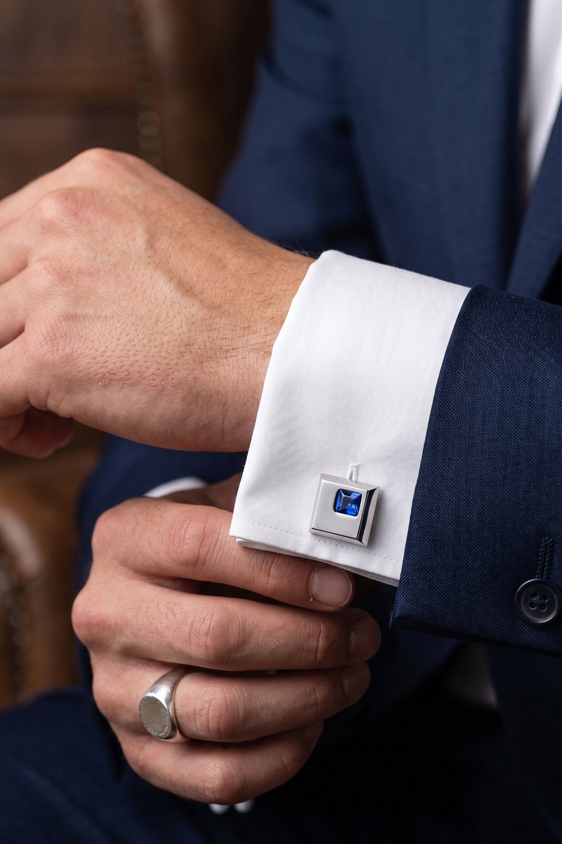 Henry Silver men’s cufflinks with blue crystal accents in detailed silver metalwork for refined formal elegance.
