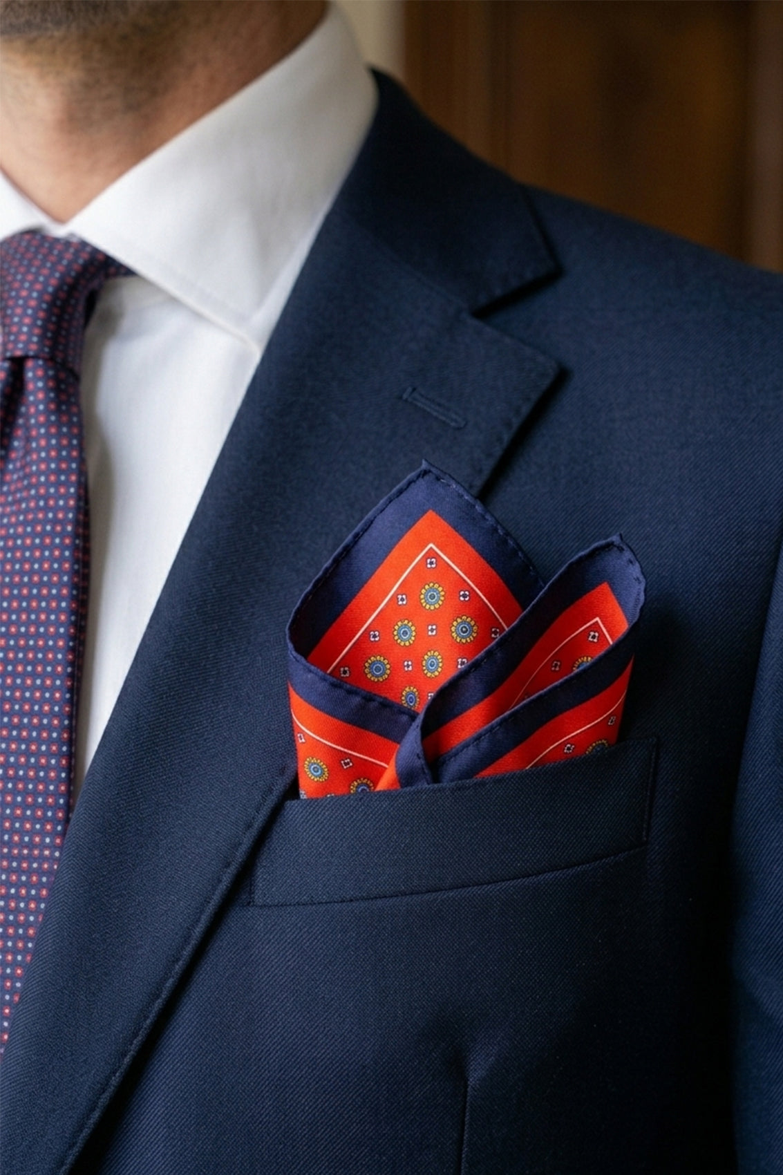 Men’s red silk pocket square with an intricate geometric pattern, crafted for weddings, formal occasions, or sophisticated smart attire.