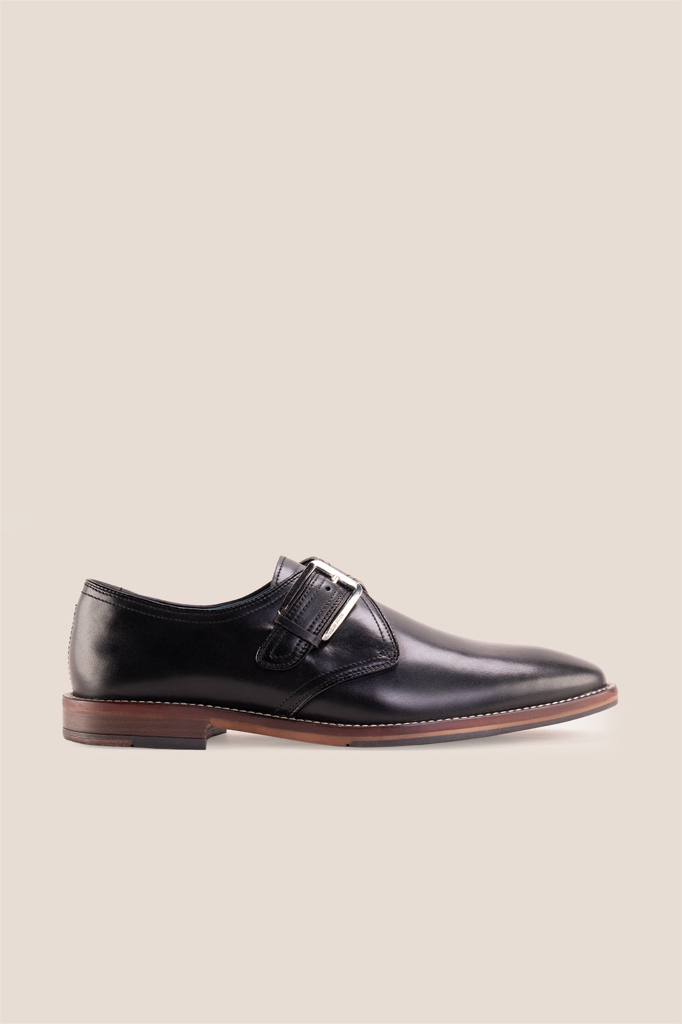 Premium men's black leather single monk strap dress shoes by Oswin Hyde London featuring a plain toe, adjustable silver buckle, contrast sole stitching, and a cushioned teal interior.