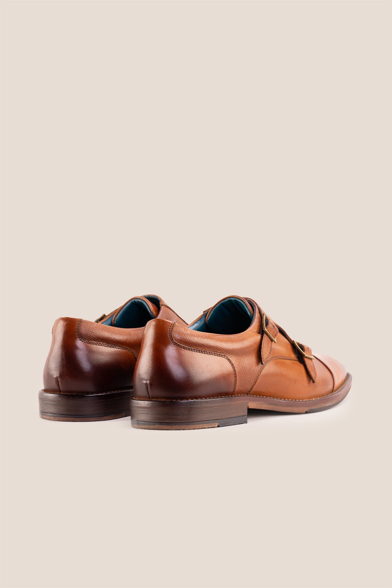 Kayden Tan leather monk strap shoes by OSWIN HYDE for men. Toe cap designed with saffiano print, cushioned insole and padded topline.
