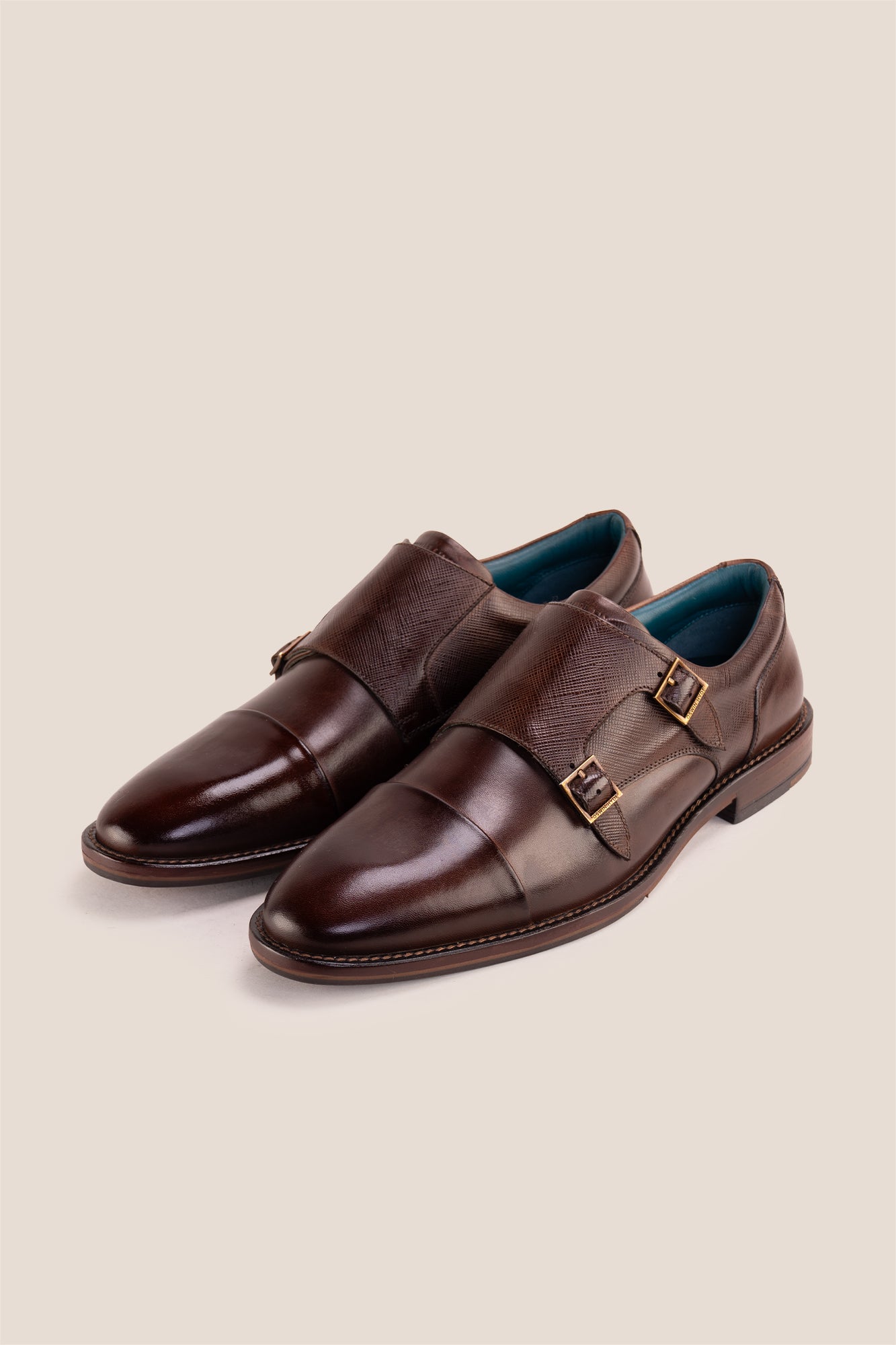 Kayden Brown leather monk strap shoes by OSWIN HYDE for men. Toe cap designed with saffiano print, cushioned insole and padded topline.