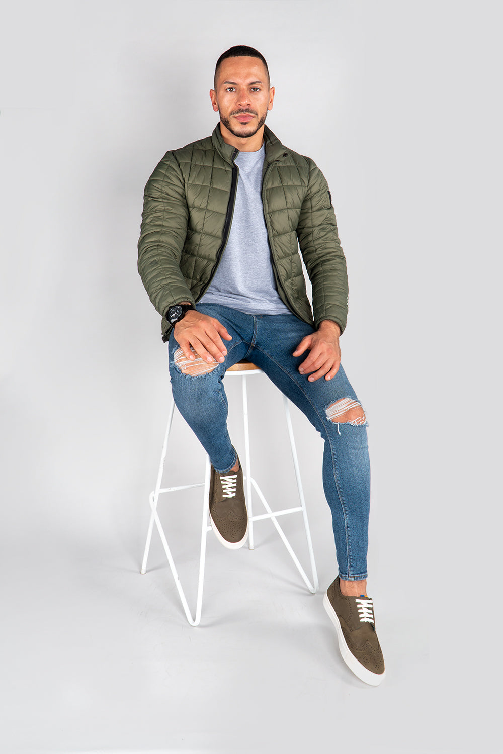 model wearing Men's khaki leather sneakers with white sole