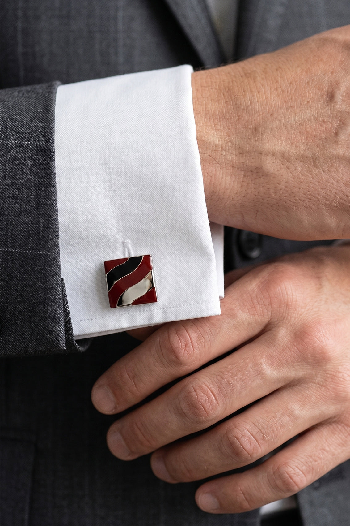 Men’s Kirk Red cufflinks with bold red enamel inlay and intricate metal detailing, crafted for precision and formal elegance.