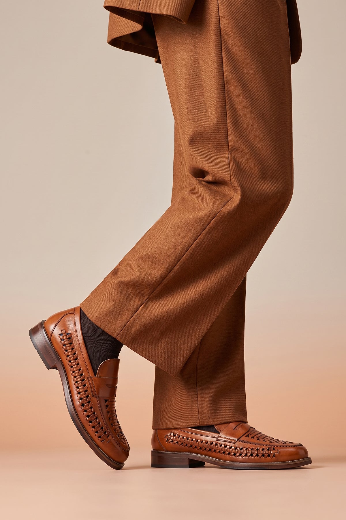 Model wearing Finley tan woven leather loafer for men, showcasing premium craftsmanship with a sophisticated and timeless design