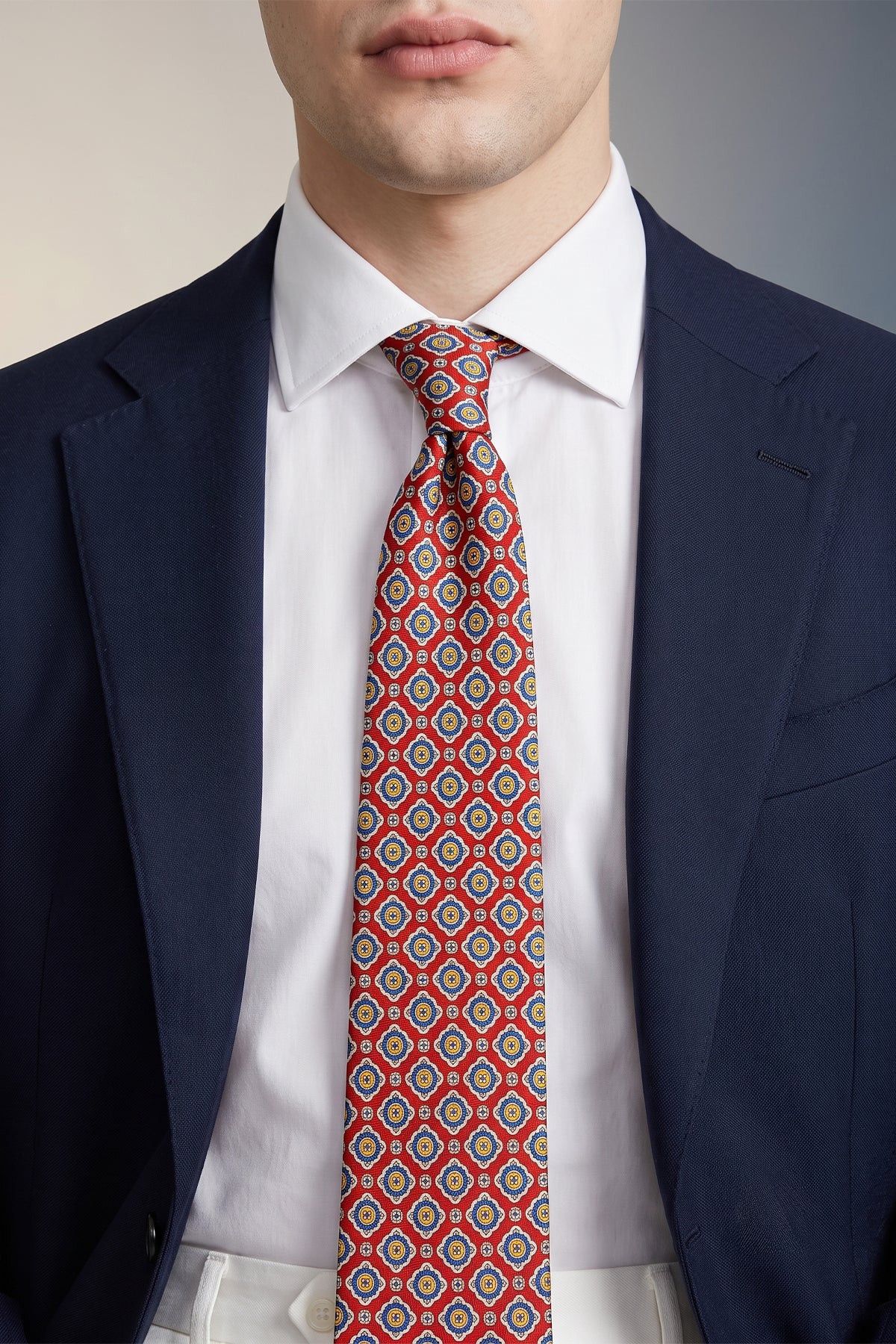 Man wearing Red Geometric Pattern Silk Tie with sophisticated design, ideal for weddings, formal events, and smart attire.