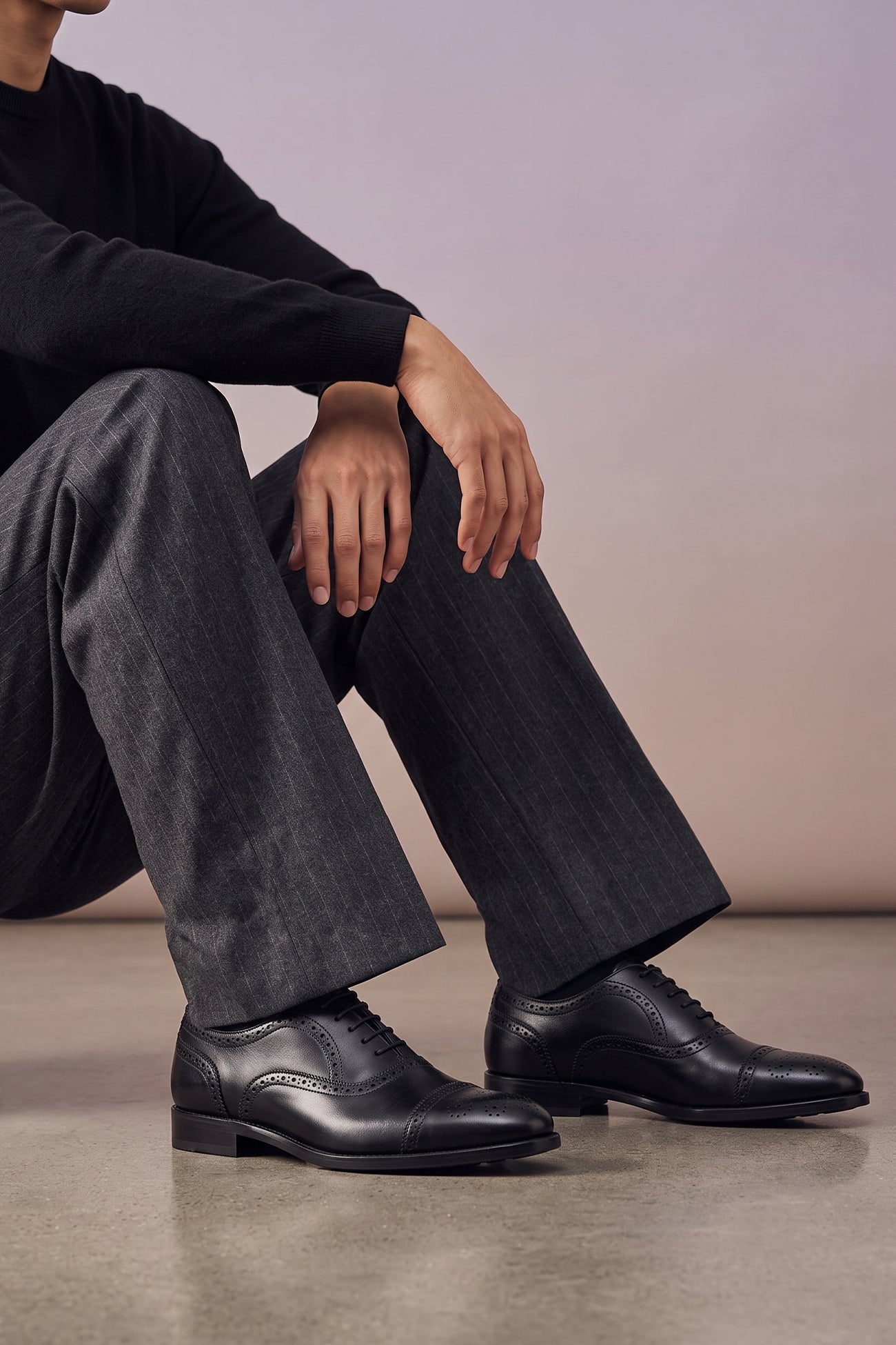 Model wearing Westminster black leather Oxford brogue shoes for men, featuring a five-eyelet lace-up and classic toecap detail for a polished formal look.